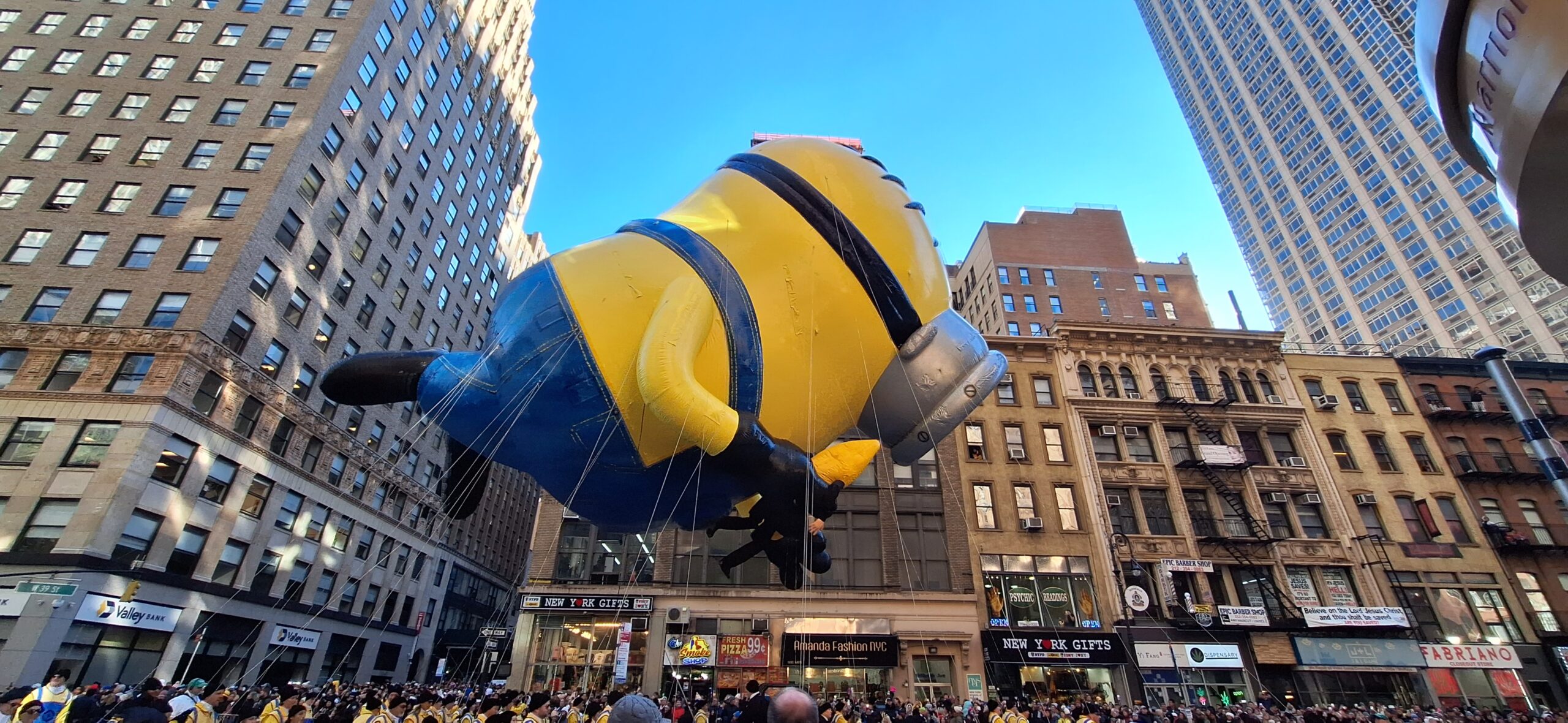 a large yellow and blue balloon in a city
