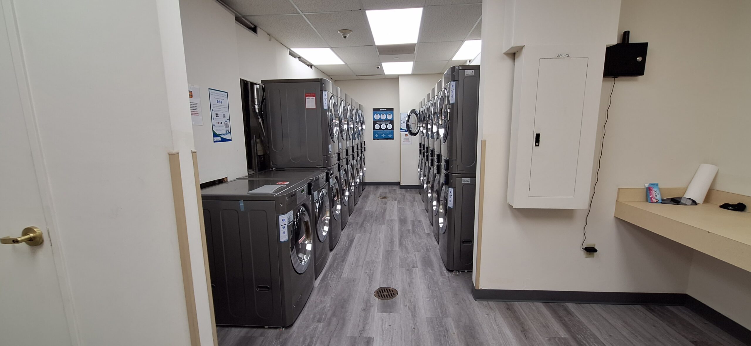 a laundry room with several washing machines