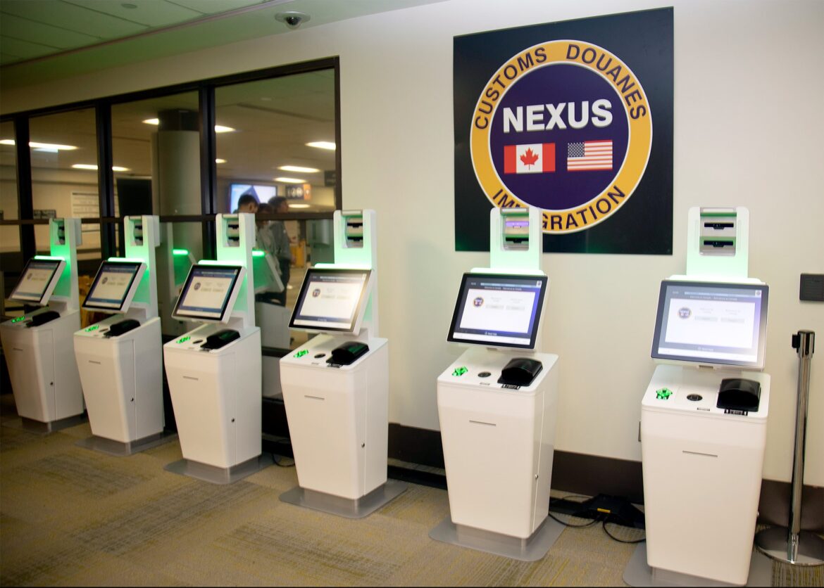 Nexus kiosks a row of white rectangular electronic devices