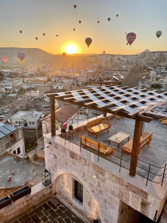 hot air balloons flying over a building