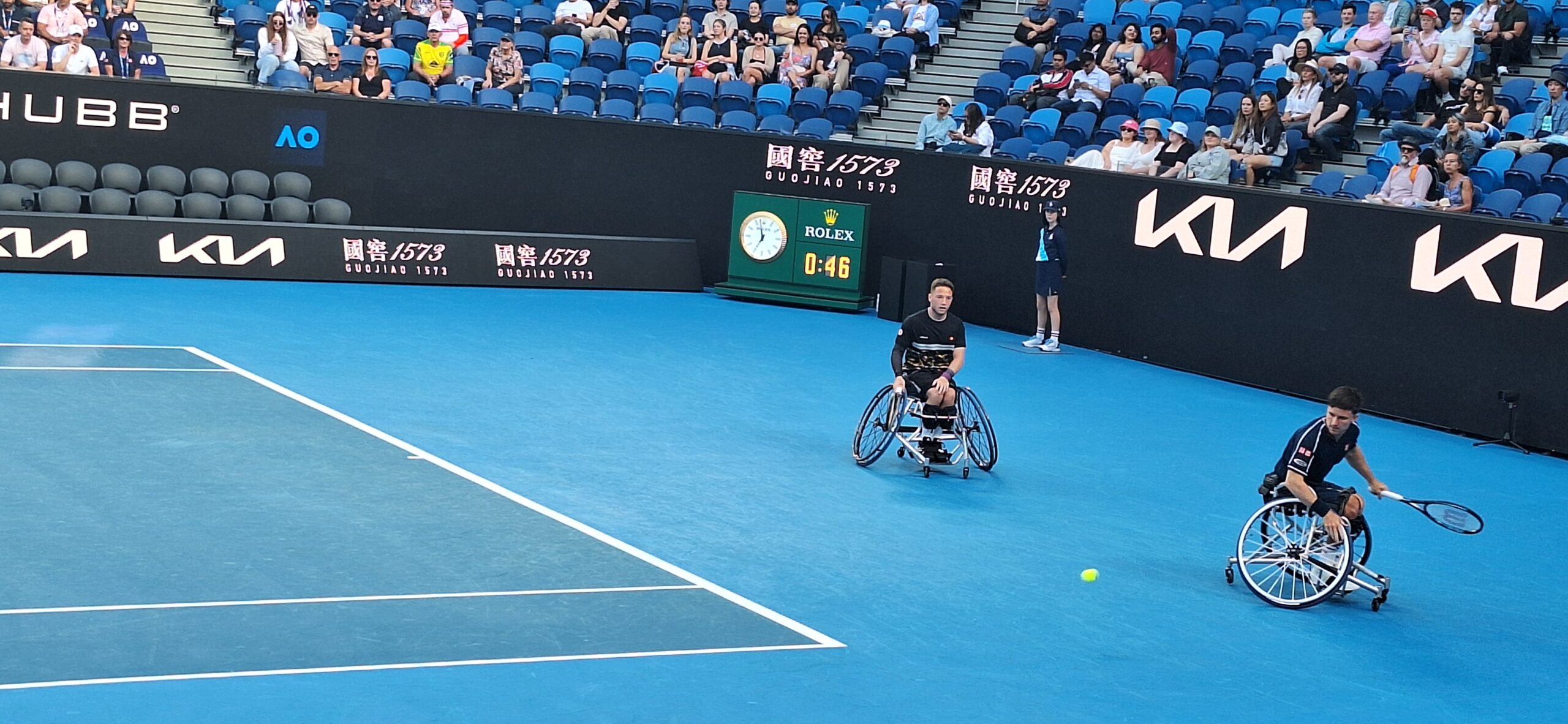 a man in a wheelchair playing tennis