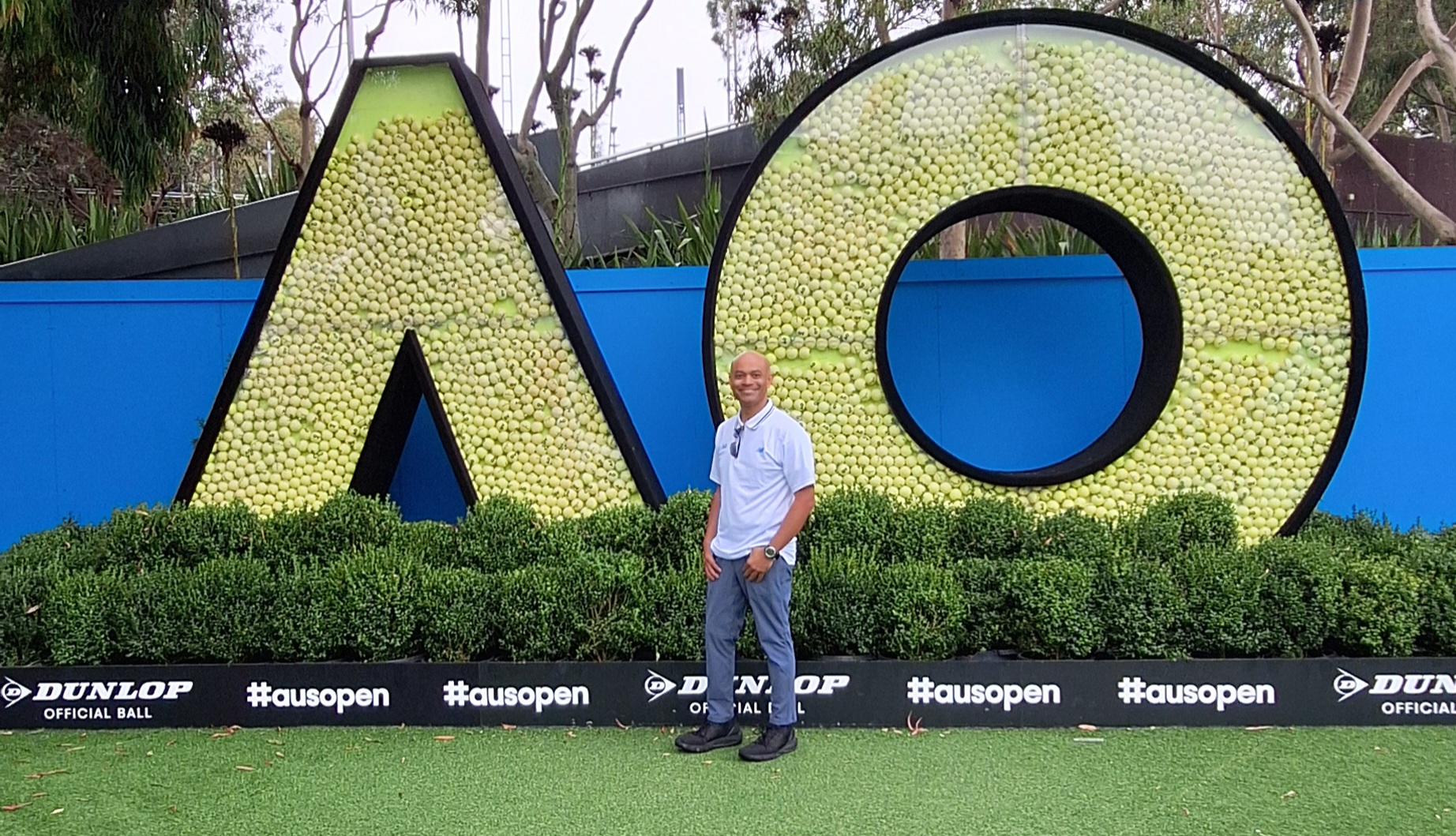 a man standing in front of a large sign