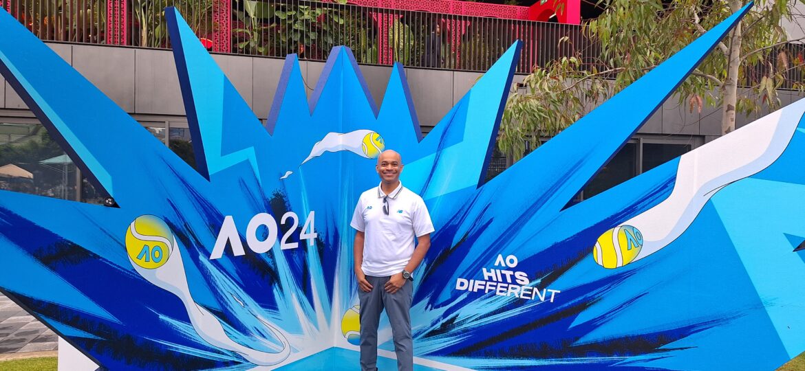Aus Open – Me at the Open (2) a man standing in front of a blue sign