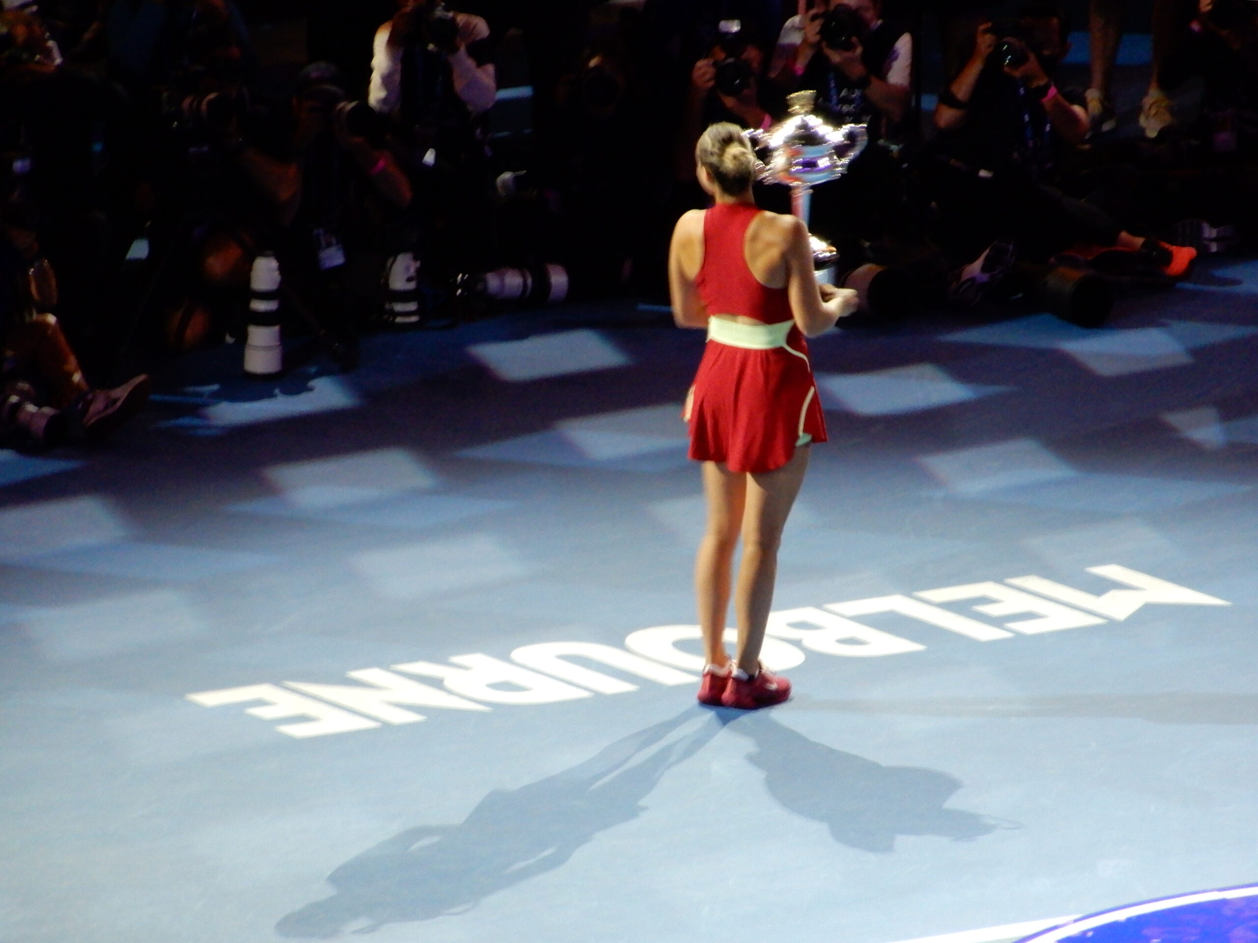 a woman holding a trophy