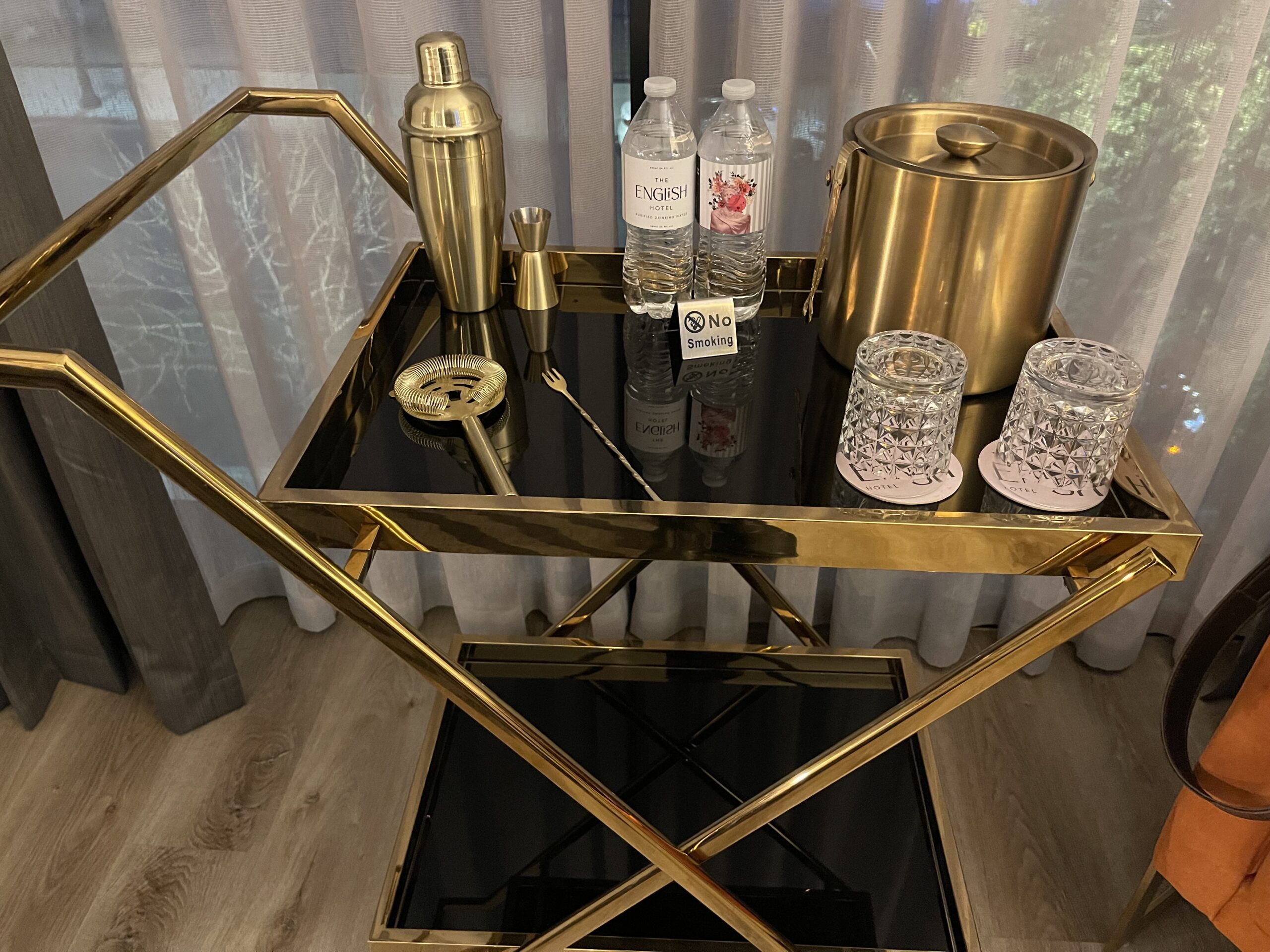 a bar cart with gold objects on it