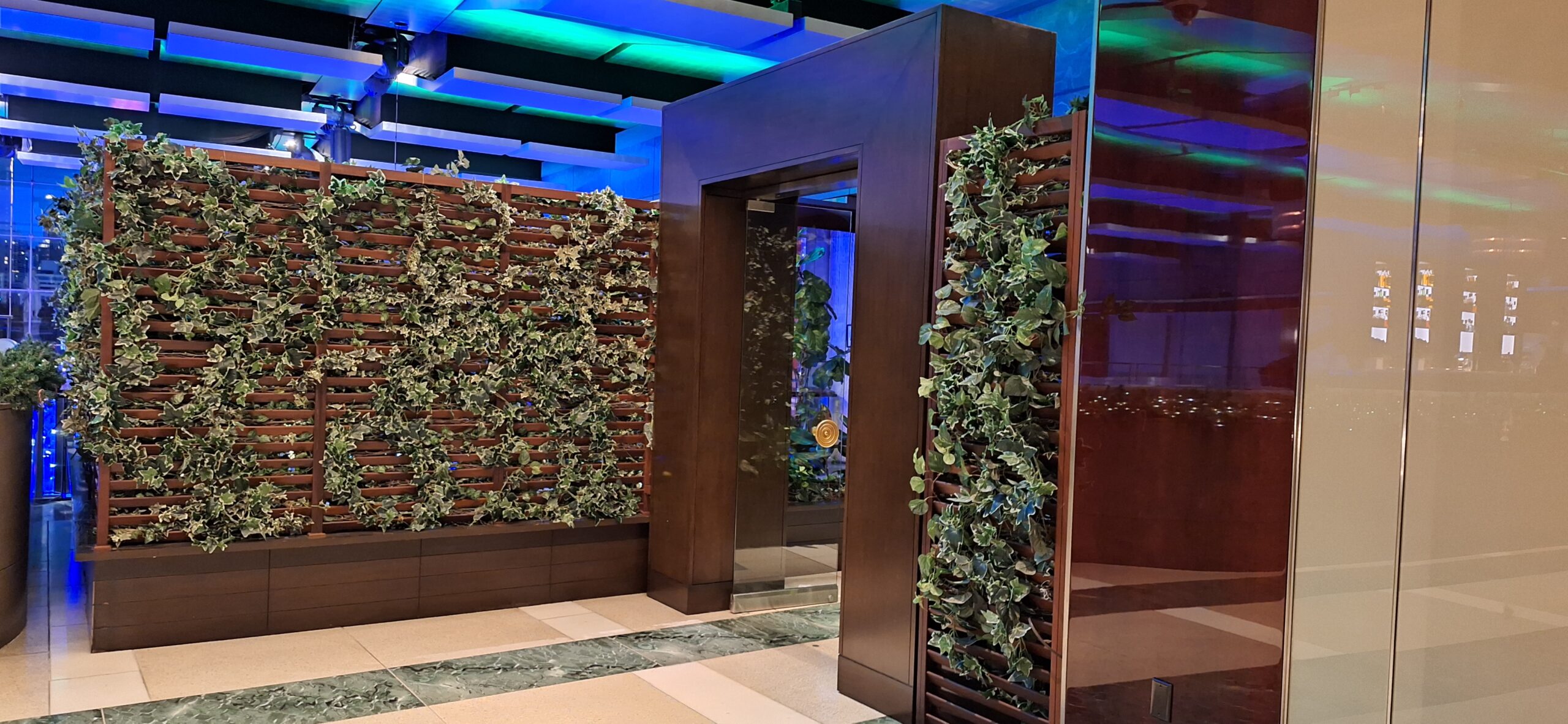a elevator with plants on the wall