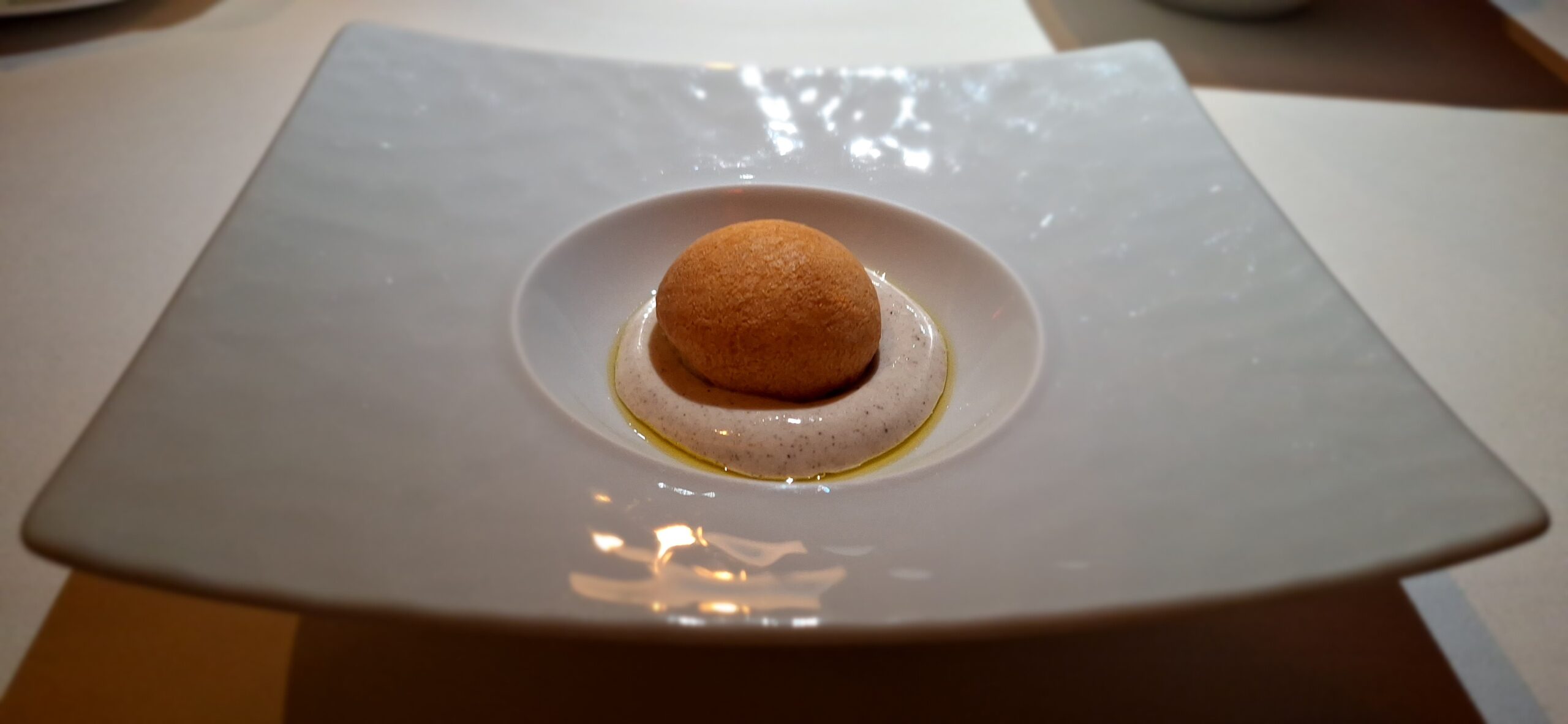 a round brown object on a white plate