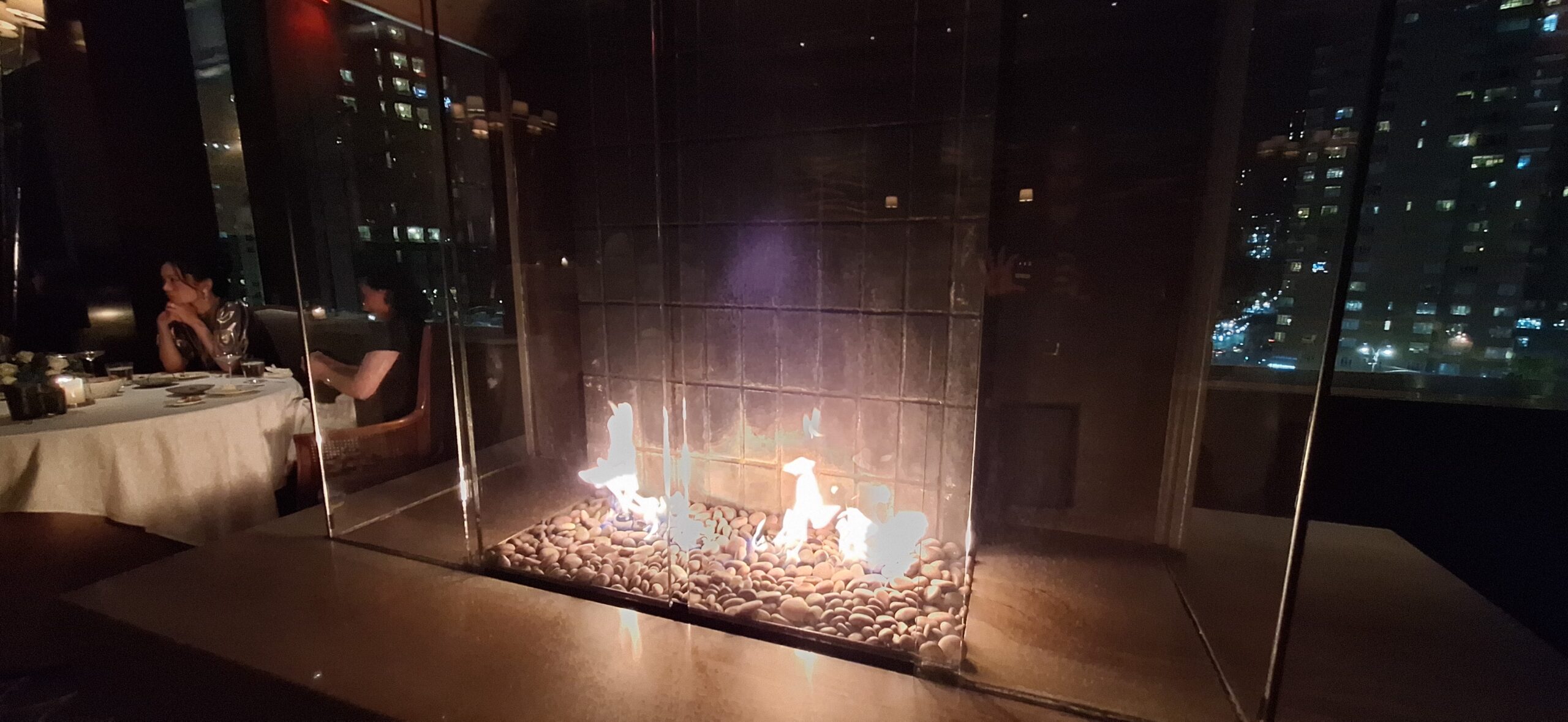 a fire in a glass fireplace