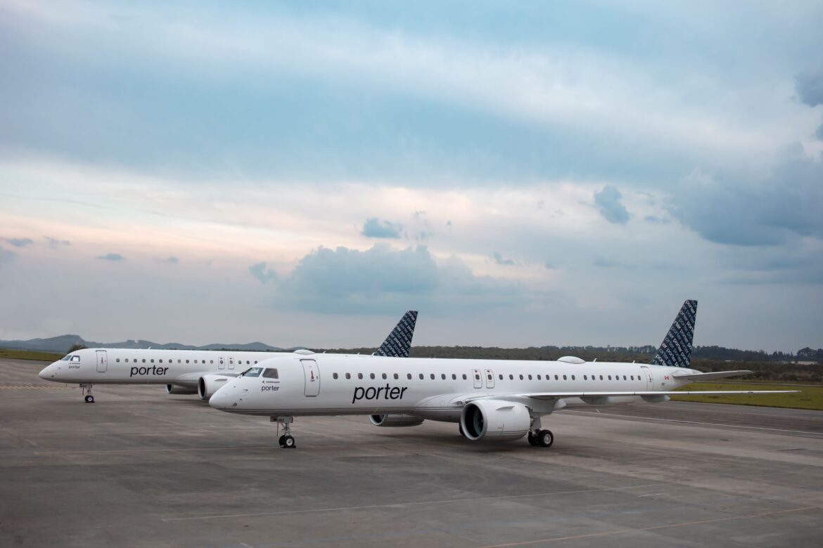 a group of white airplanes on a runway