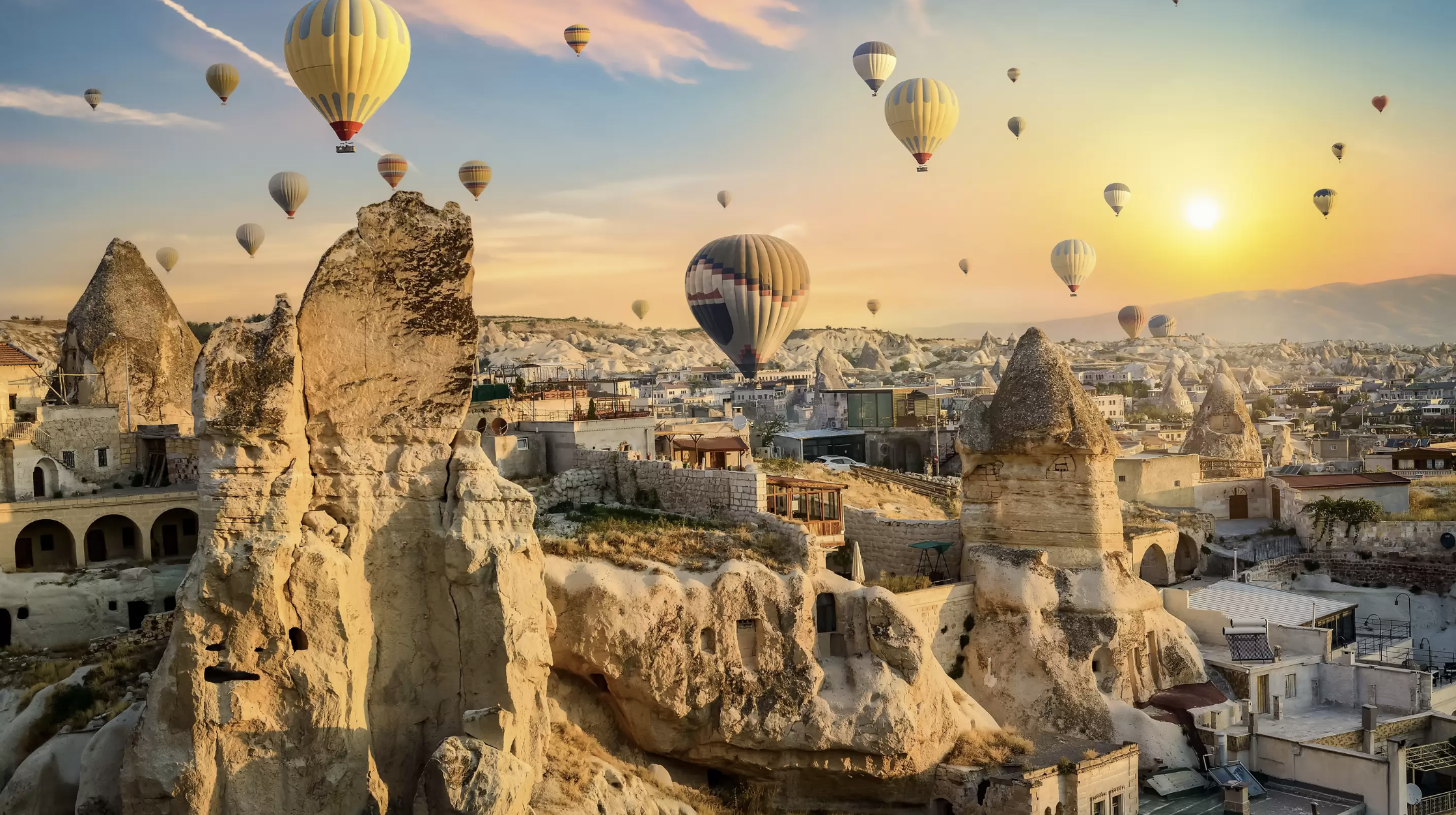 hot air balloons flying over a city
