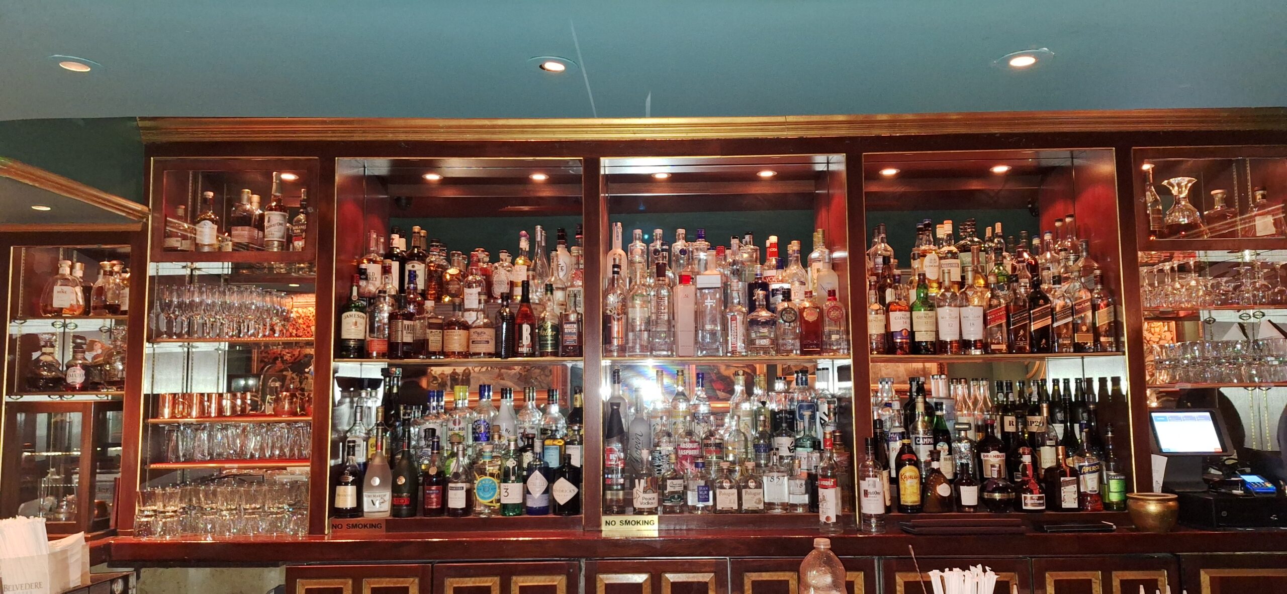 a shelf of liquor bottles