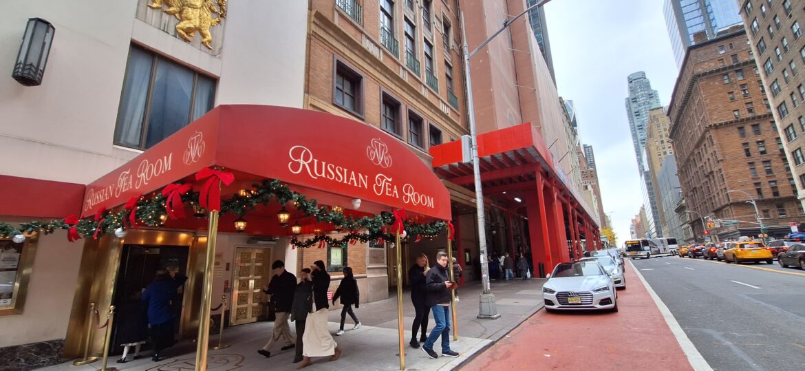 a group of people walking on a sidewalk
