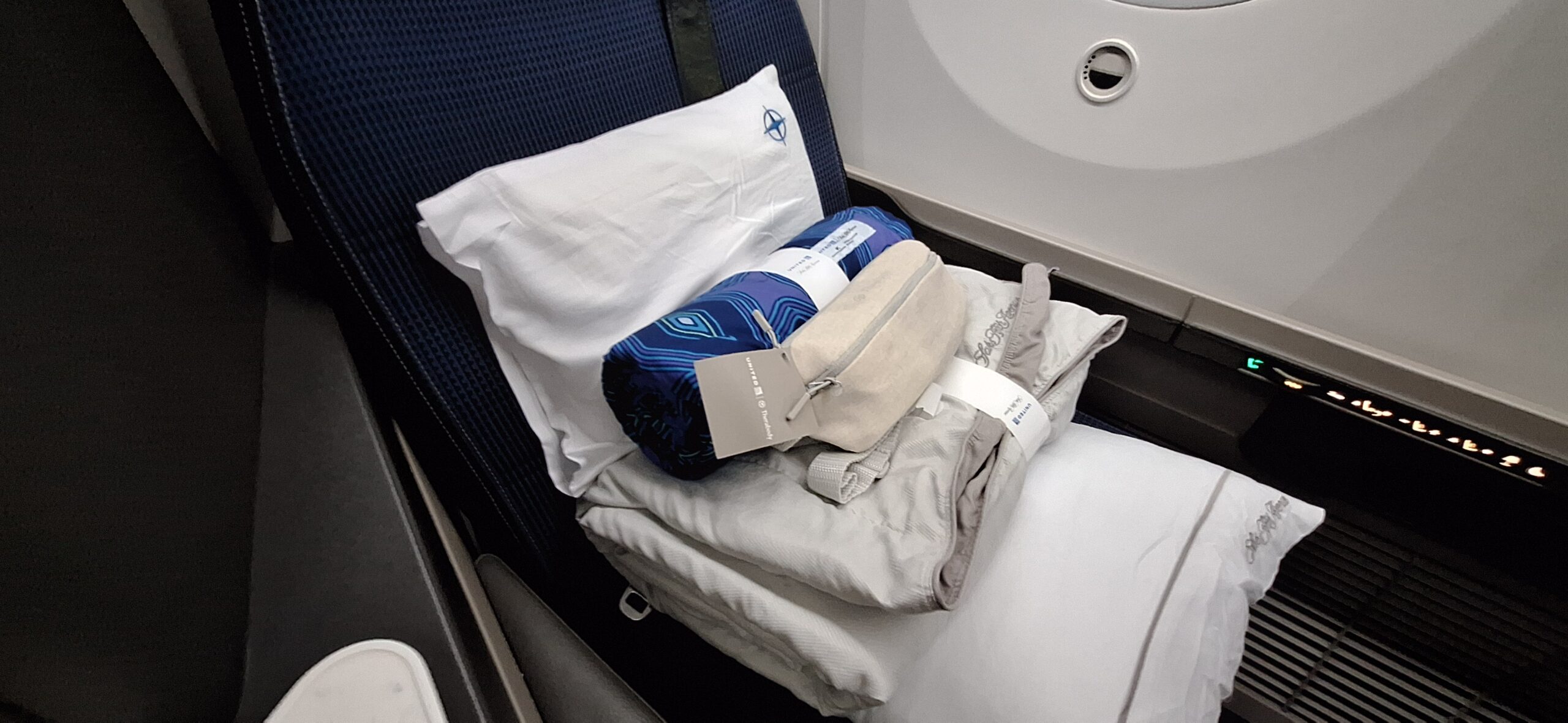 a pillow and blanket on a seat