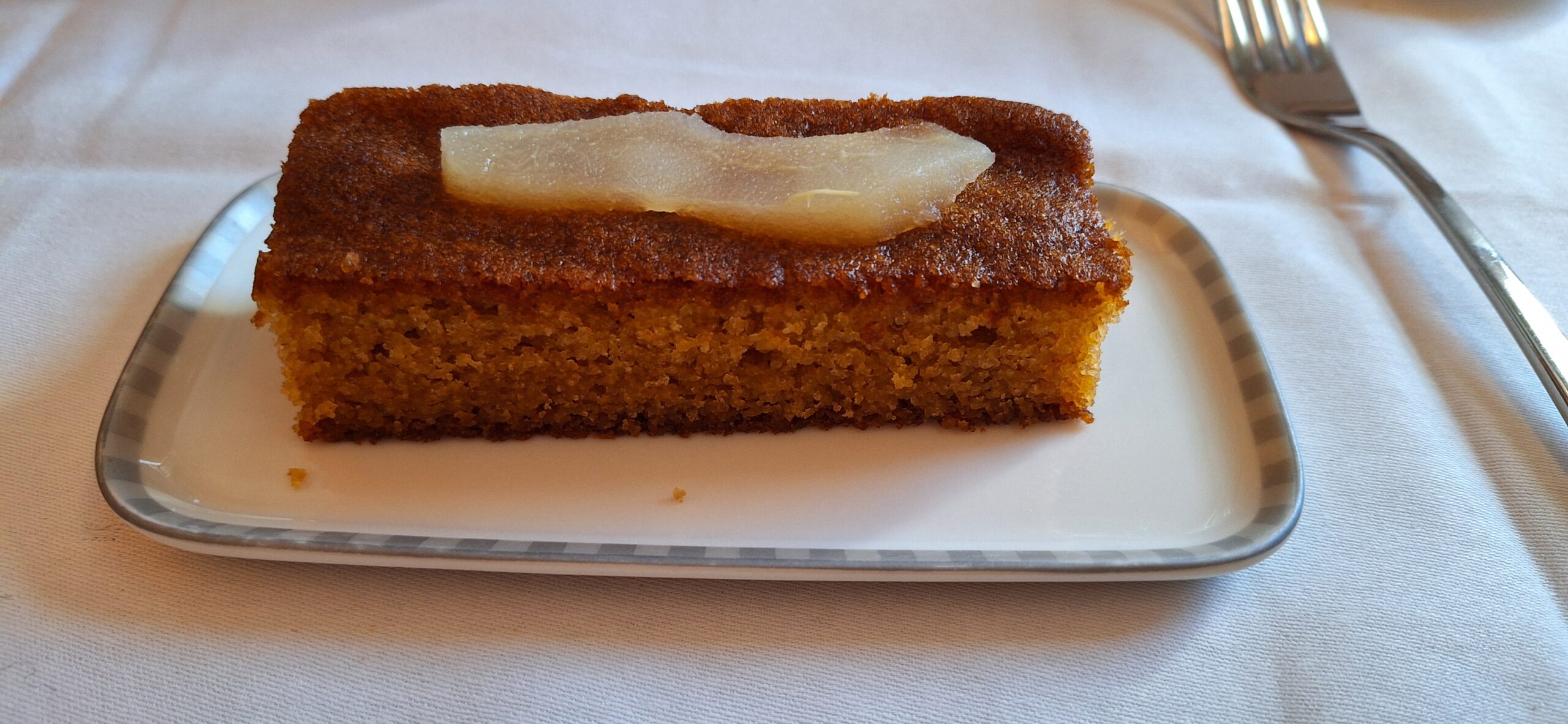 a piece of cake with pear on top