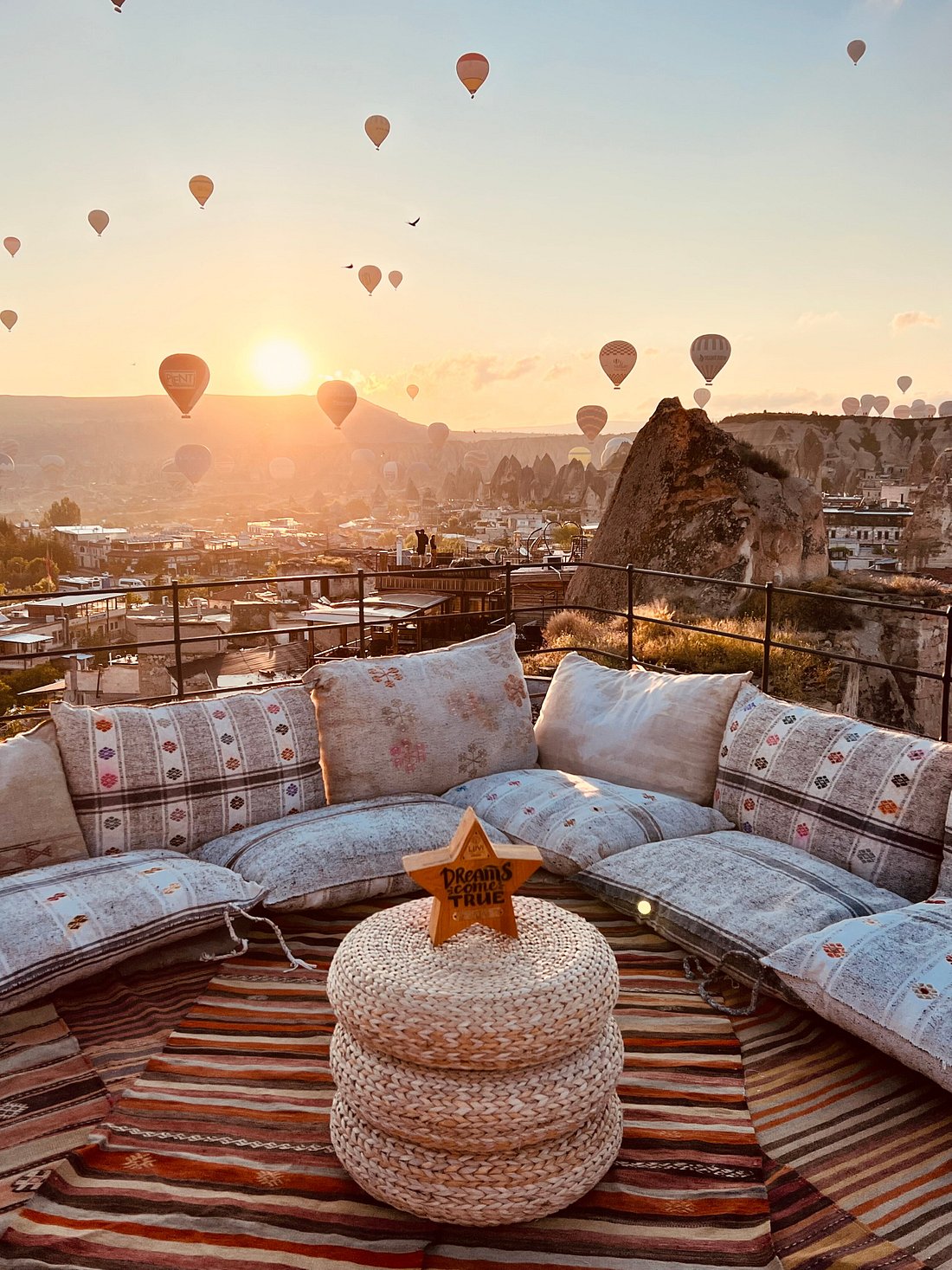 a couch and a table with hot air balloons in the sky