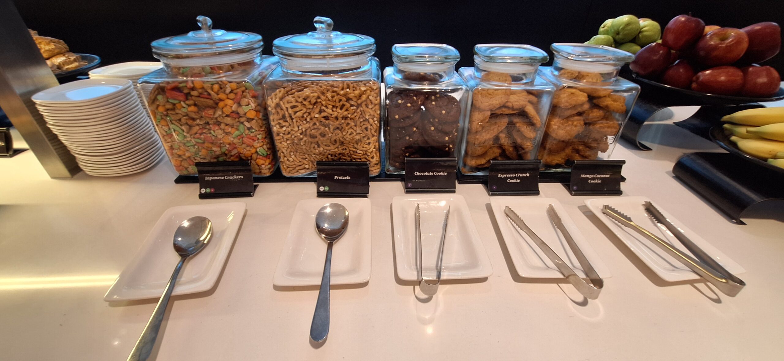 a row of glass containers with food and utensils