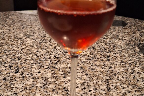 a glass of wine on a marbled counter