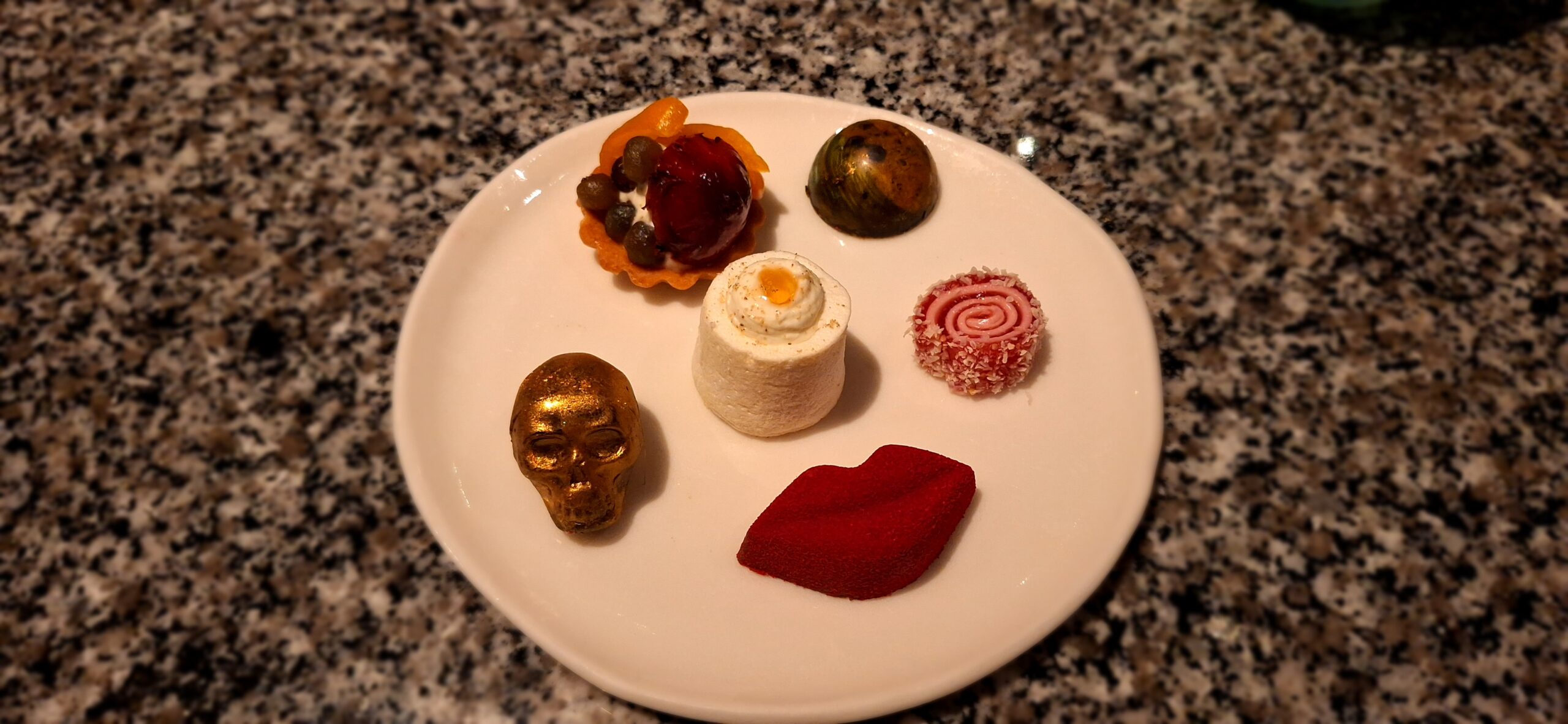 a plate of desserts on a marbled surface