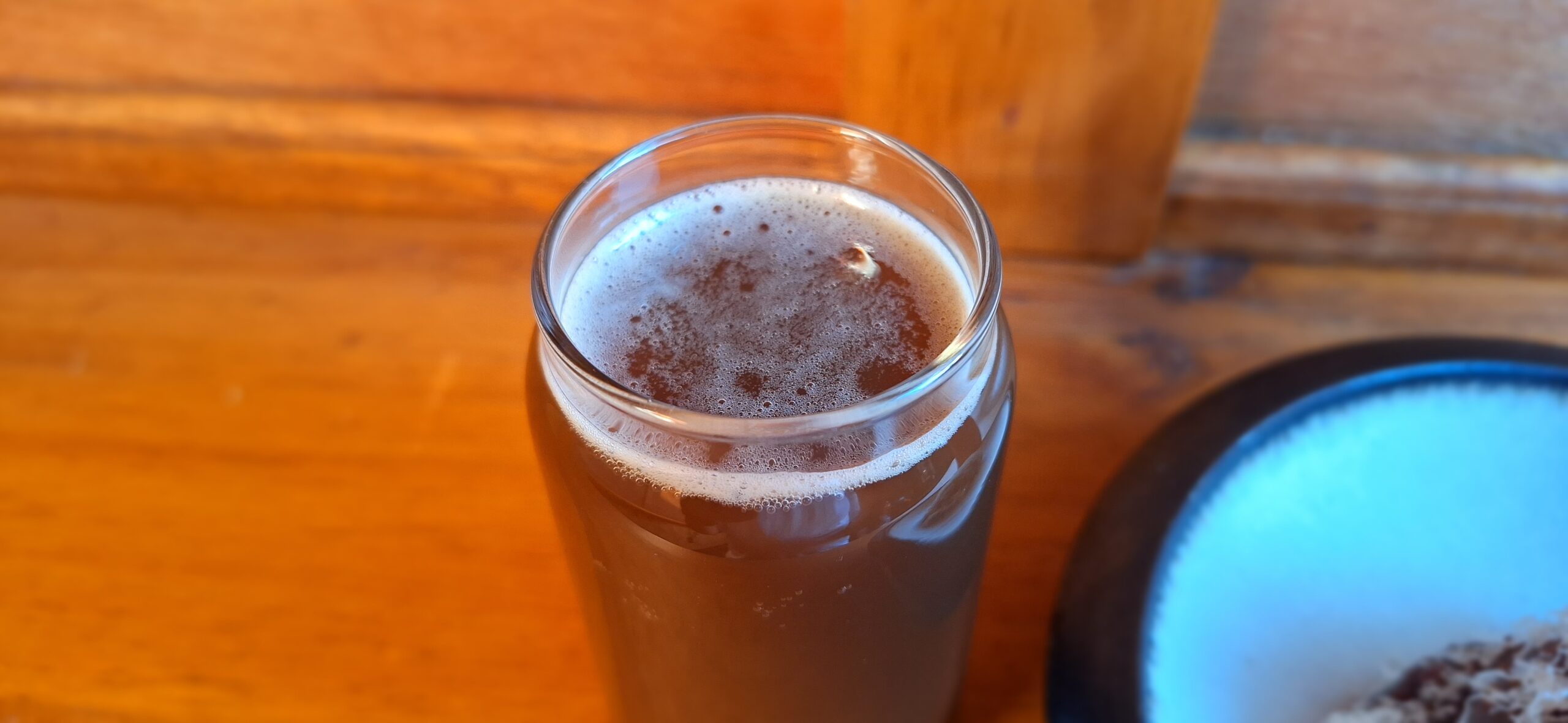 a glass of brown liquid