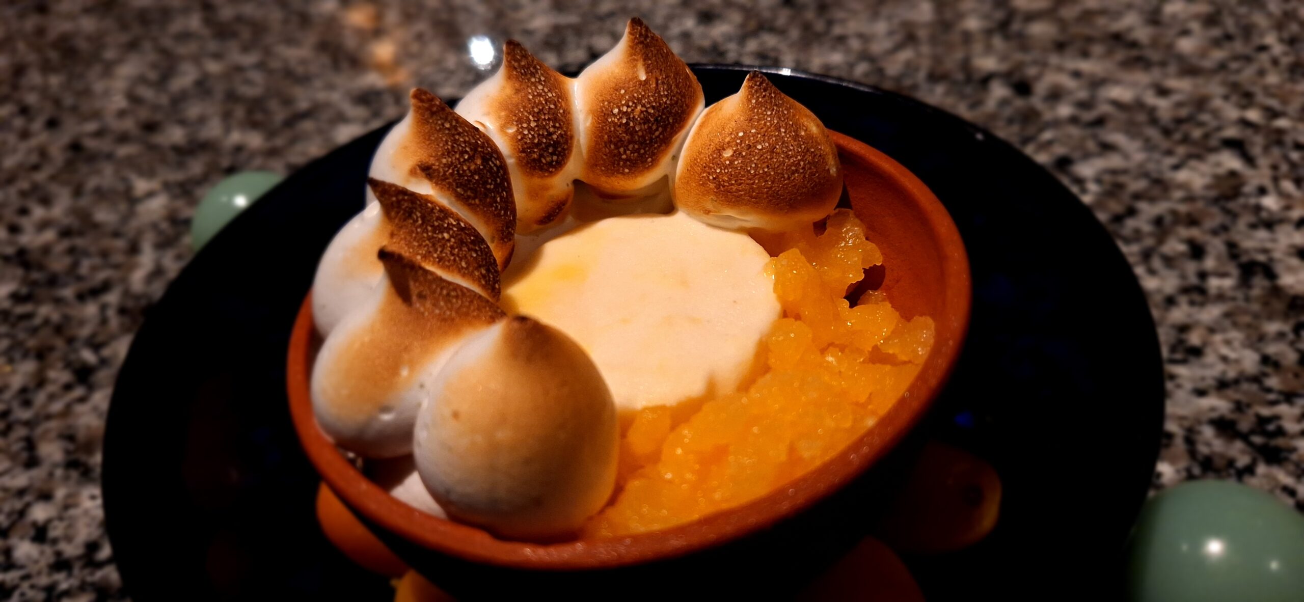 a bowl of food with a white sauce and marshmallows