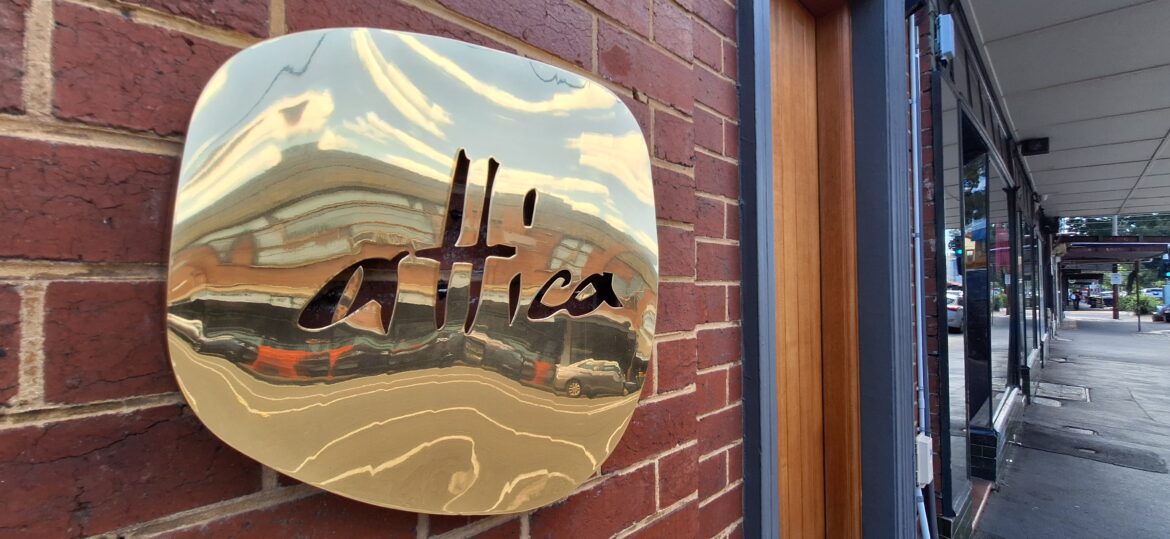 a sign on a brick wall