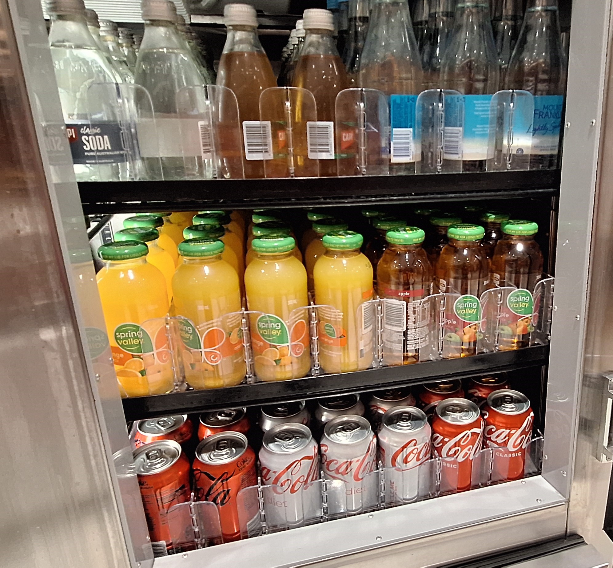 a refrigerator with drinks and cans