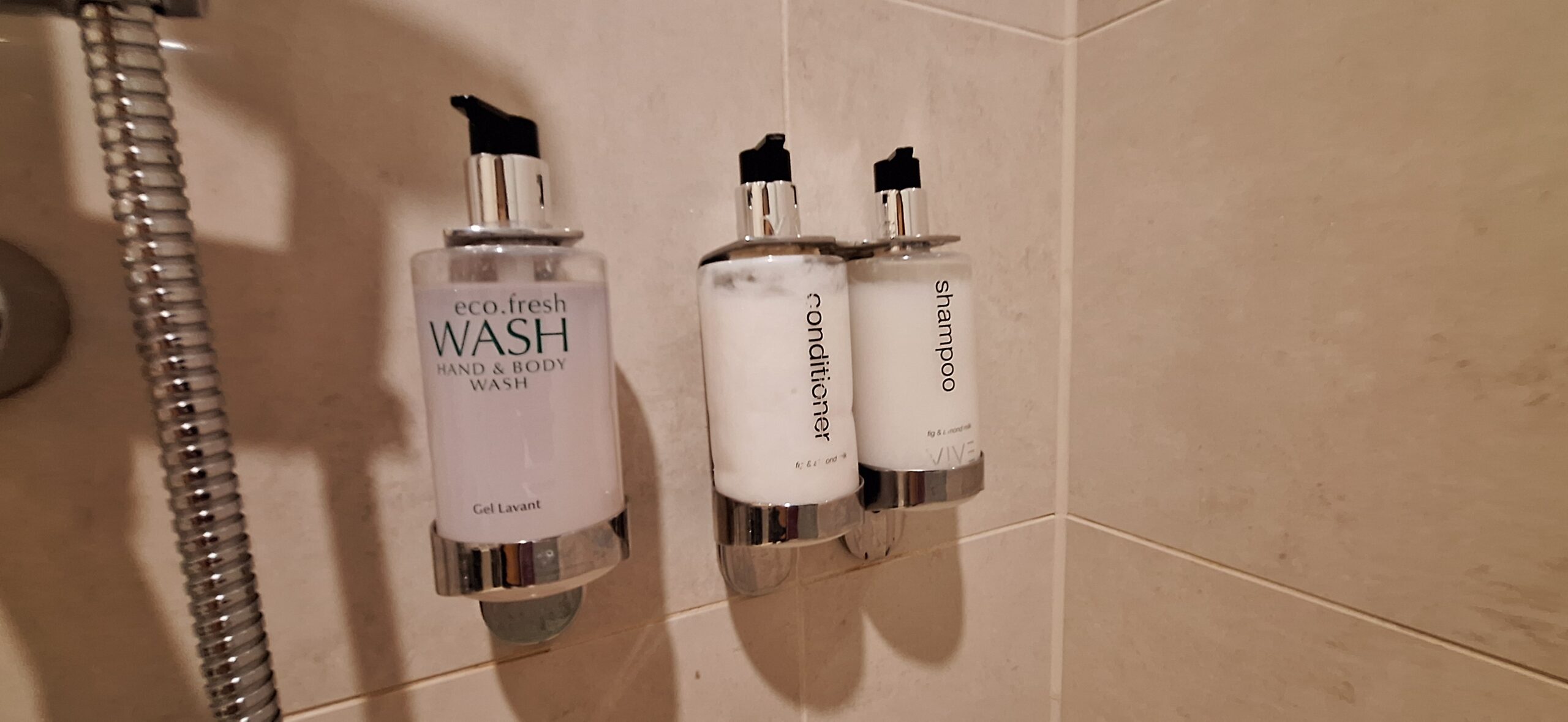 a group of soap dispensers on a wall