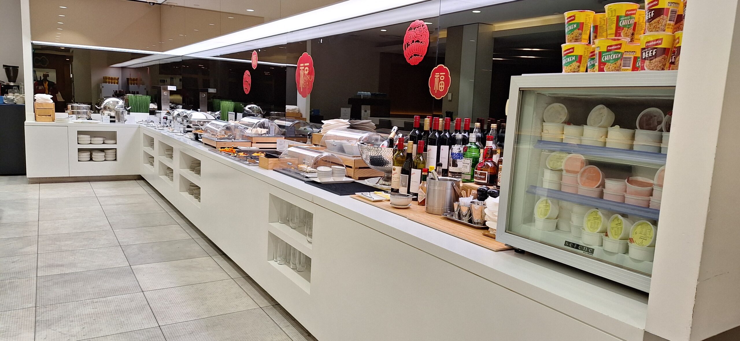 a counter with bottles of wine and other food items