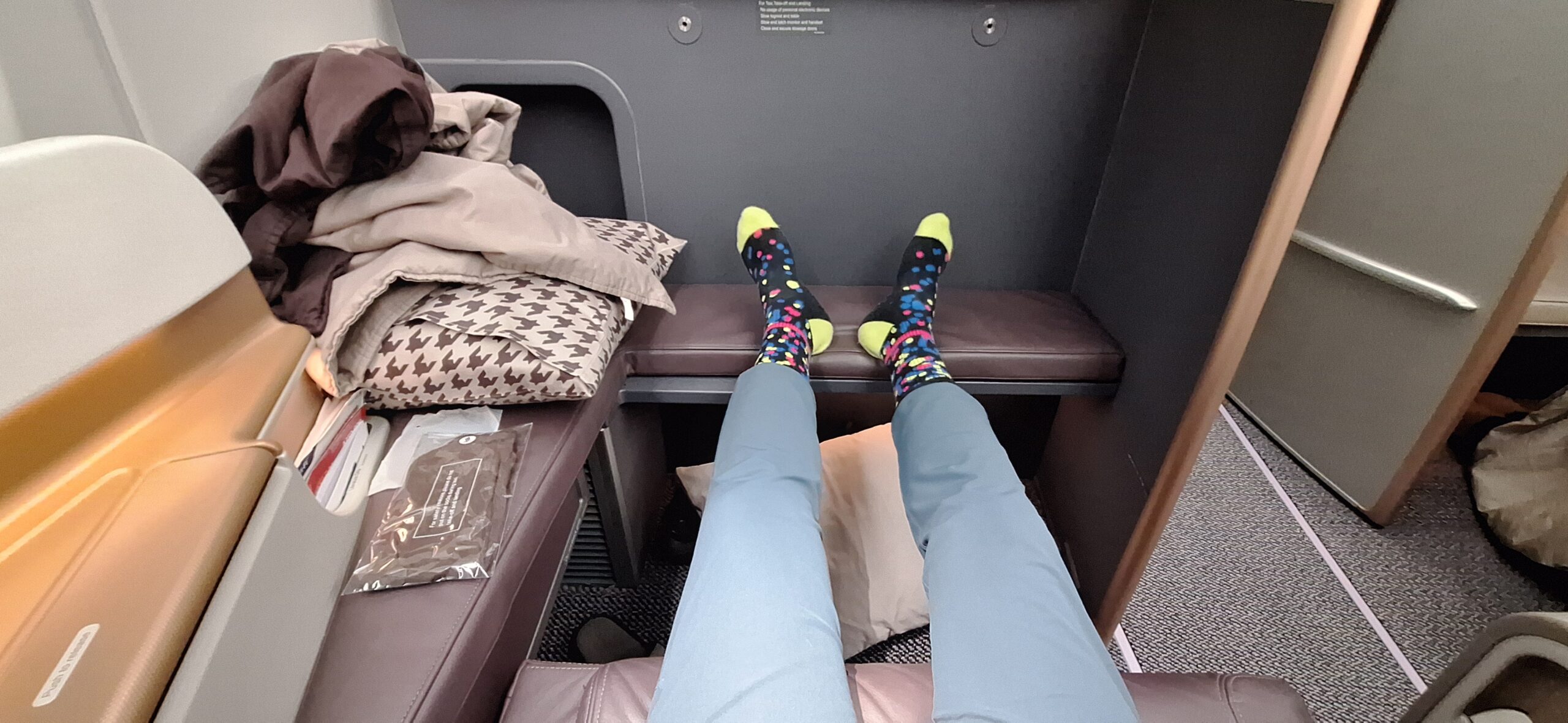 a person's legs with colorful socks on a desk