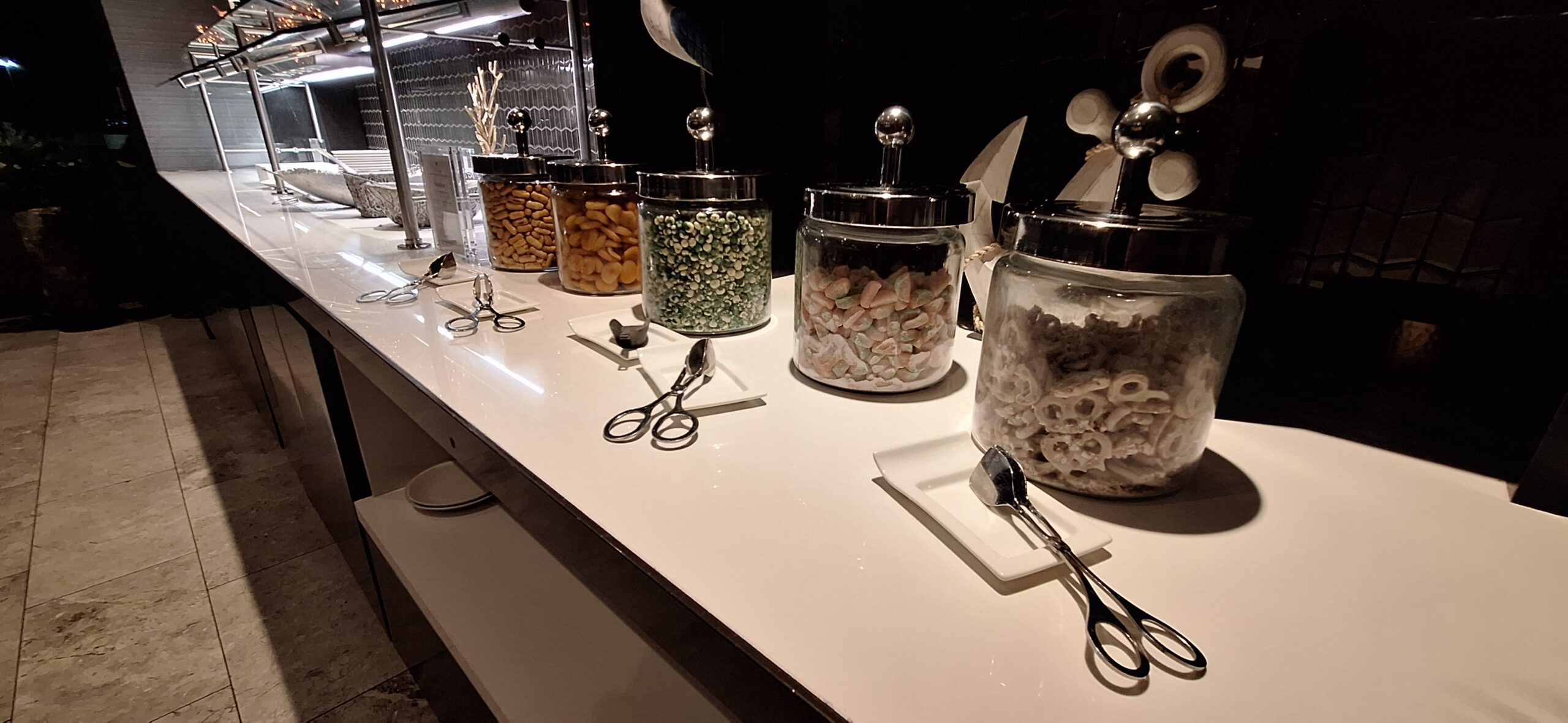 a row of glass containers with food on a counter
