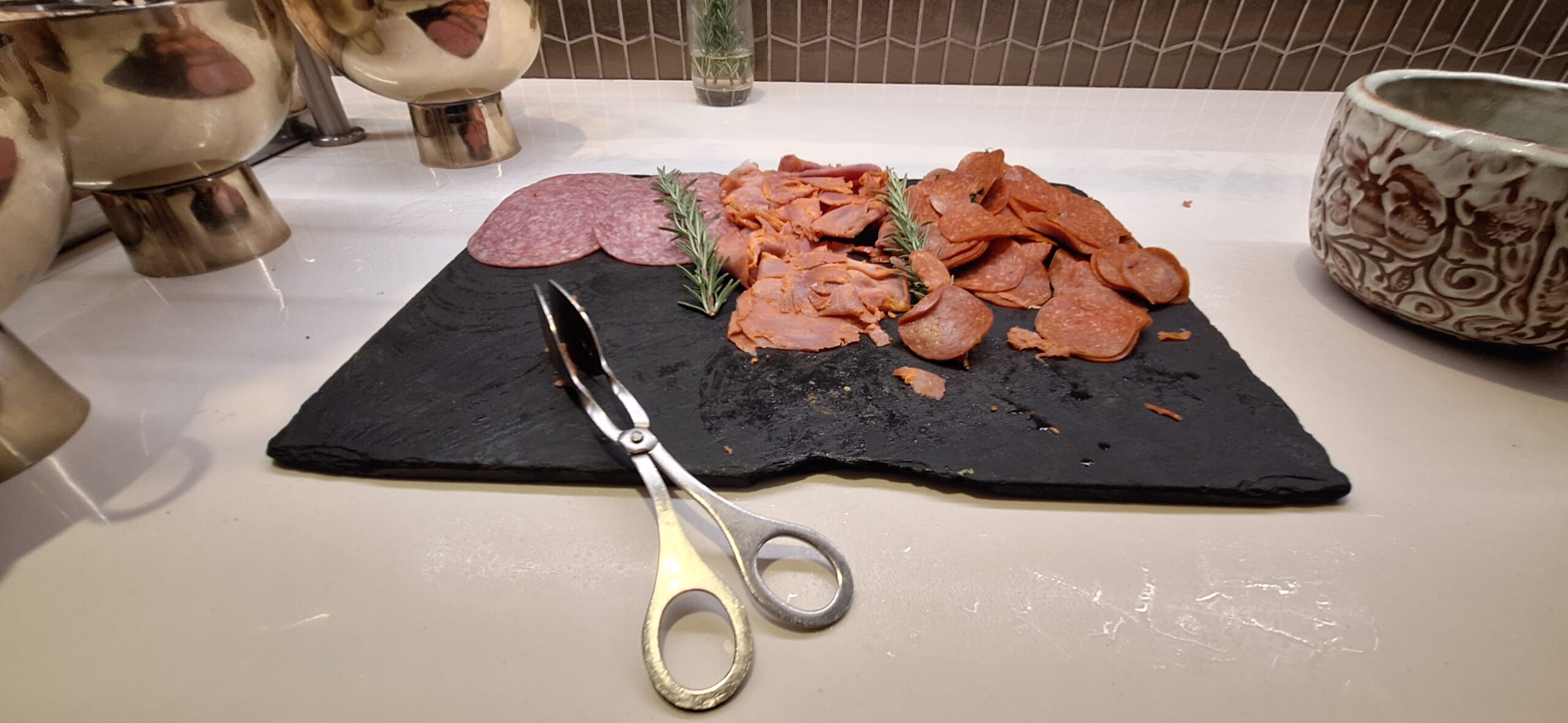 a cutting board with meat and scissors