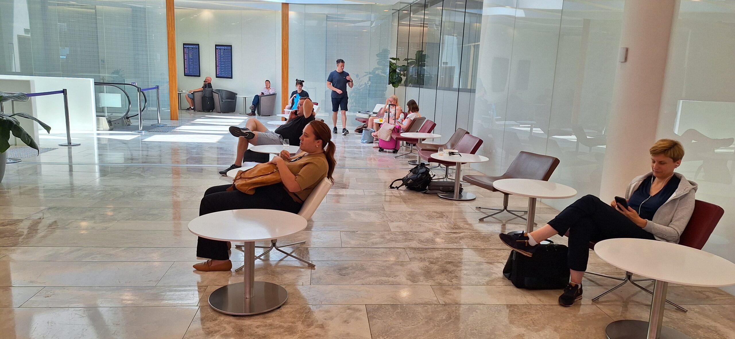 a group of people sitting in chairs in a lobby