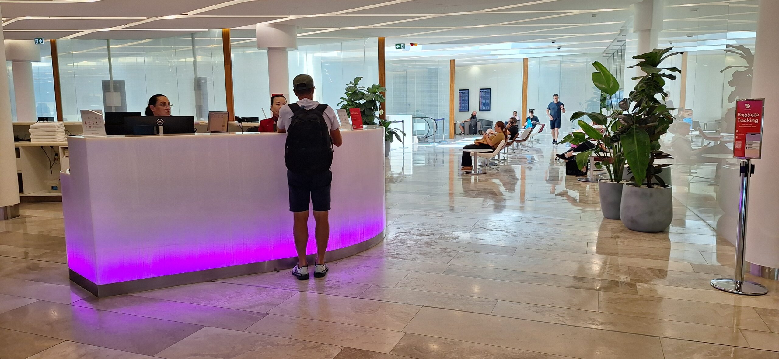 a man standing at a reception desk in a lobby