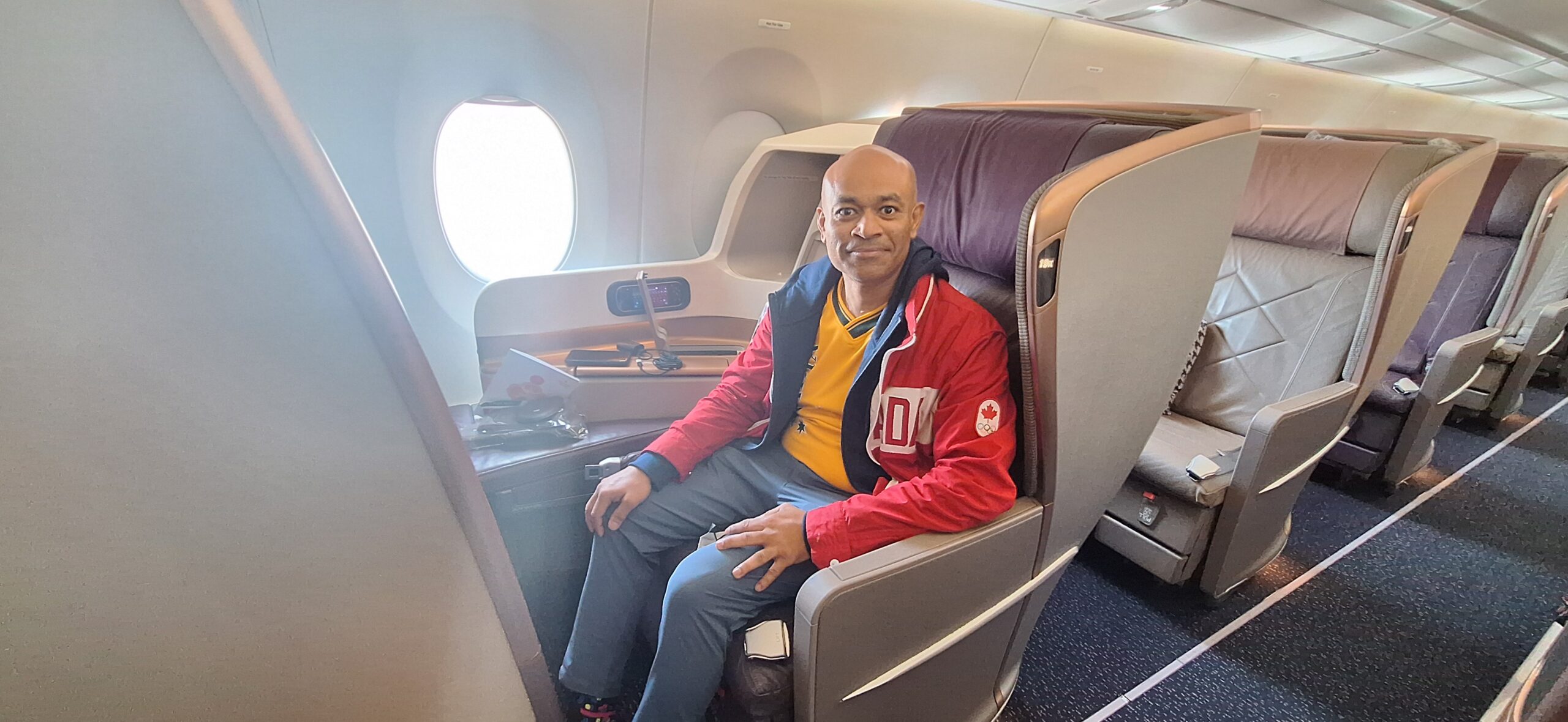 a man sitting in a chair in an airplane