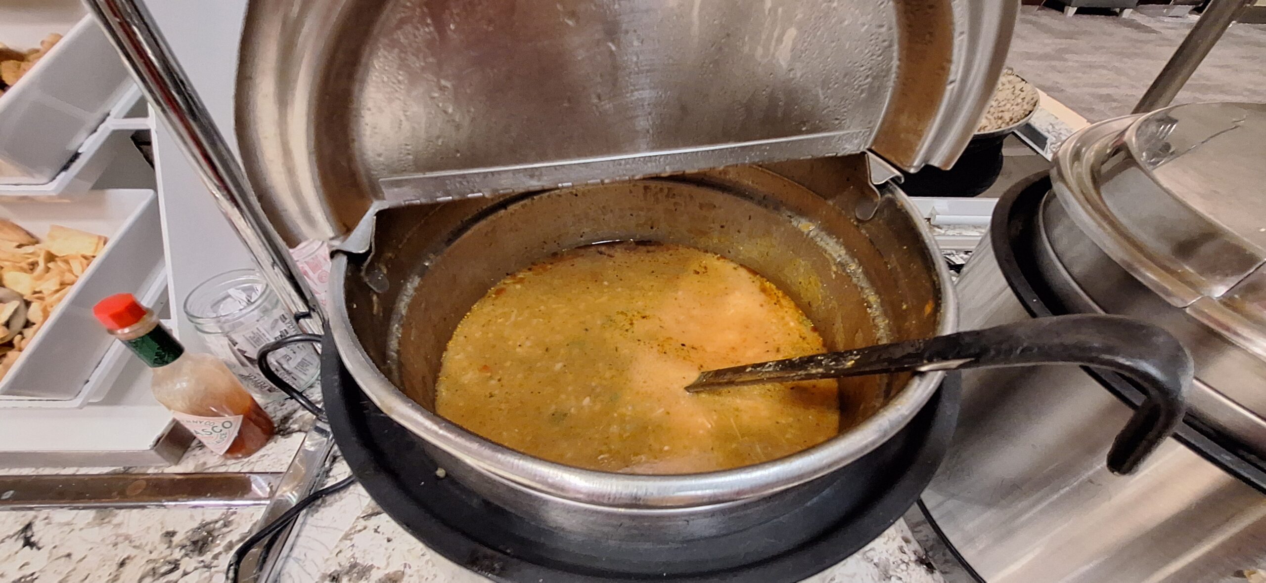 a pot of soup with a spoon inside