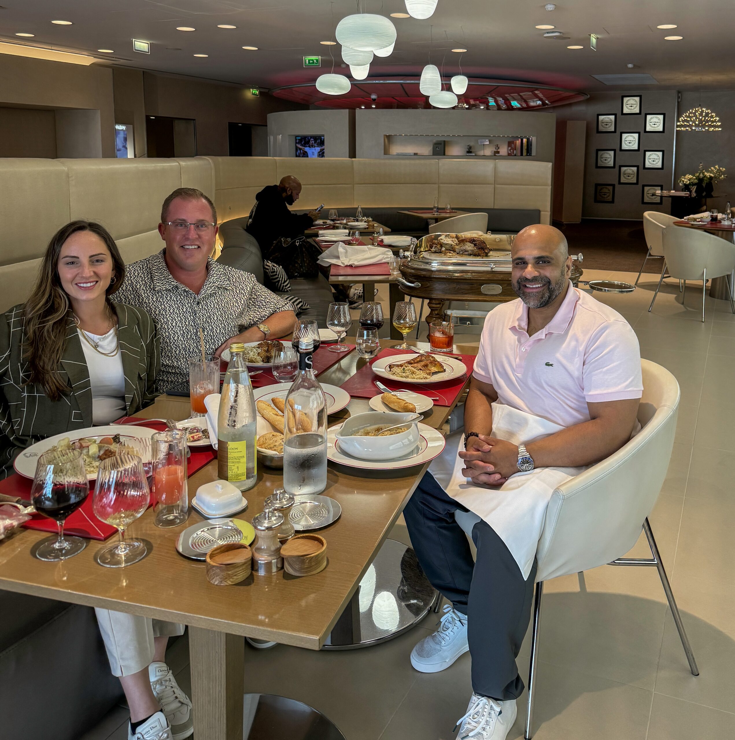 a group of people sitting at a table with food