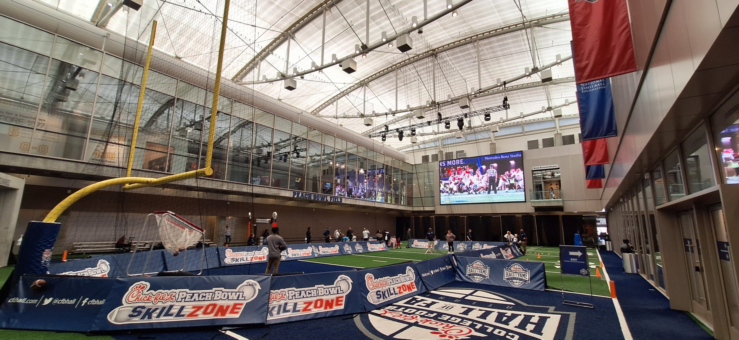 a large indoor football arena with a large screen