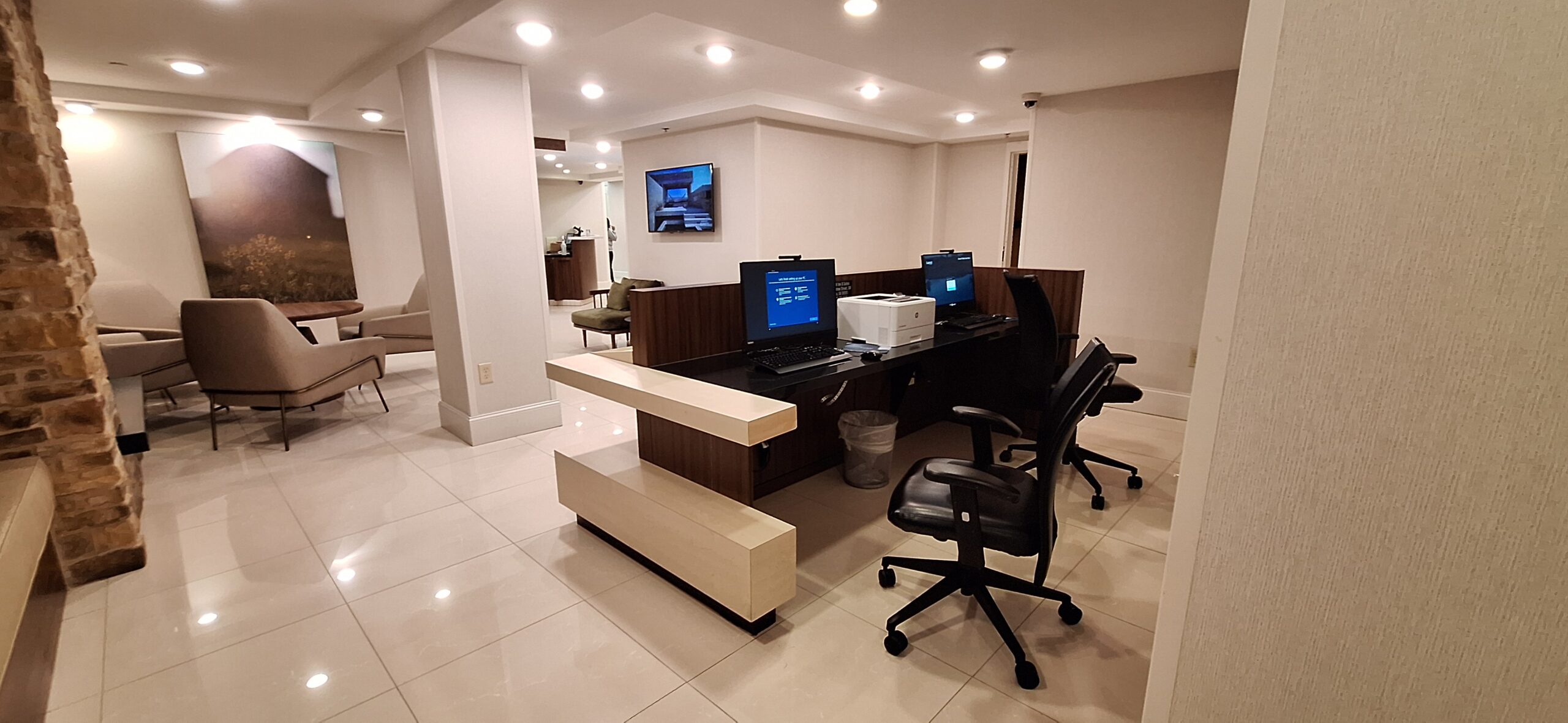 a computer desk with chairs and a chair in a room