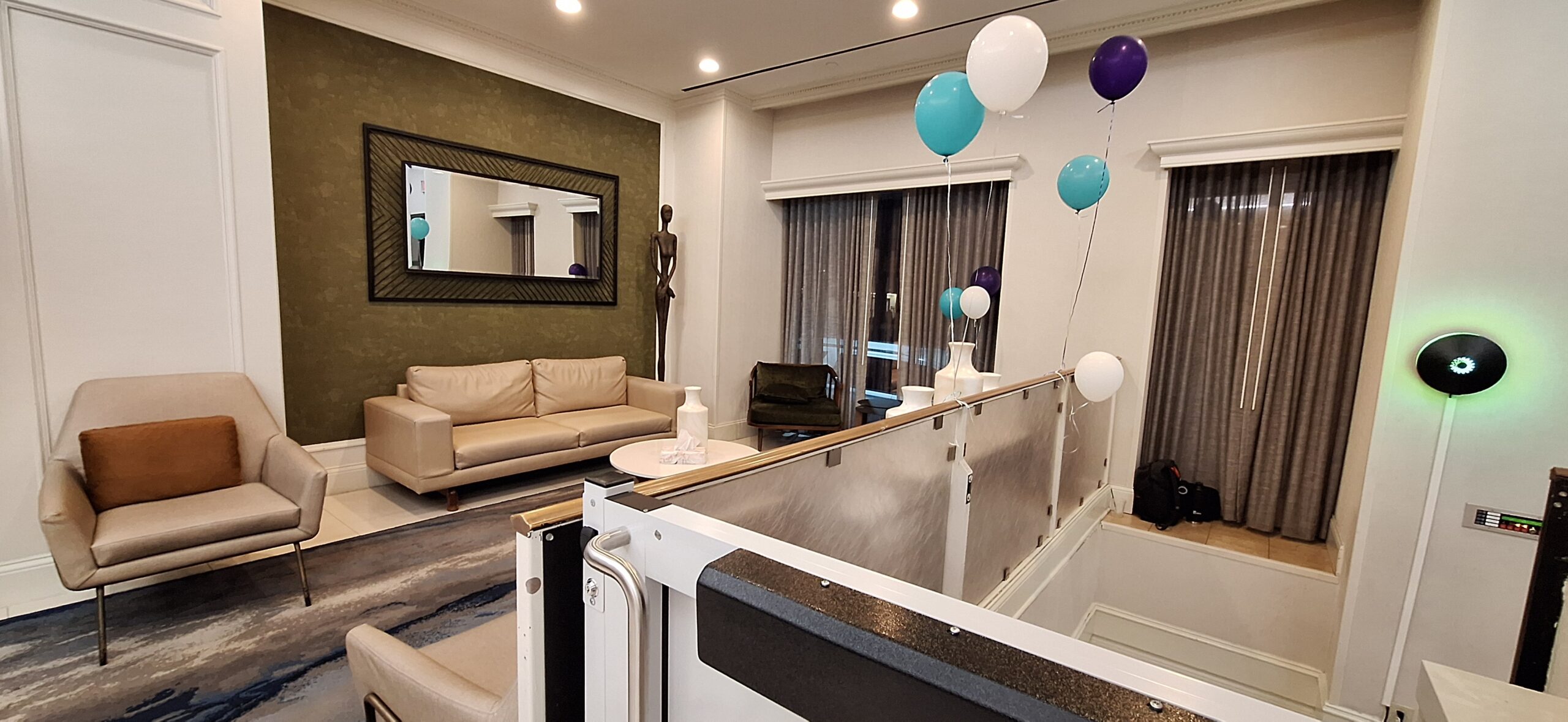 a room with a couch and balloons