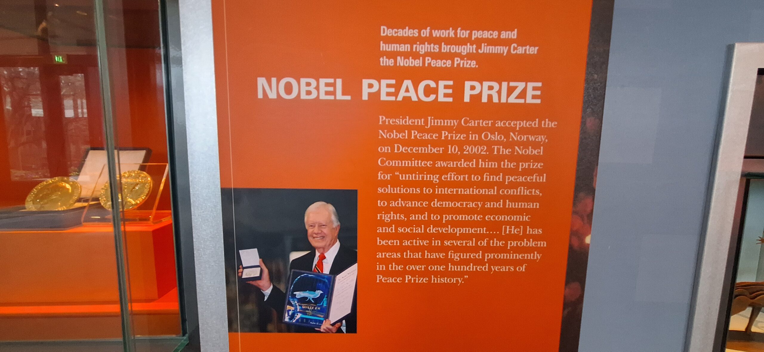 an orange book with a picture of a man holding a medal