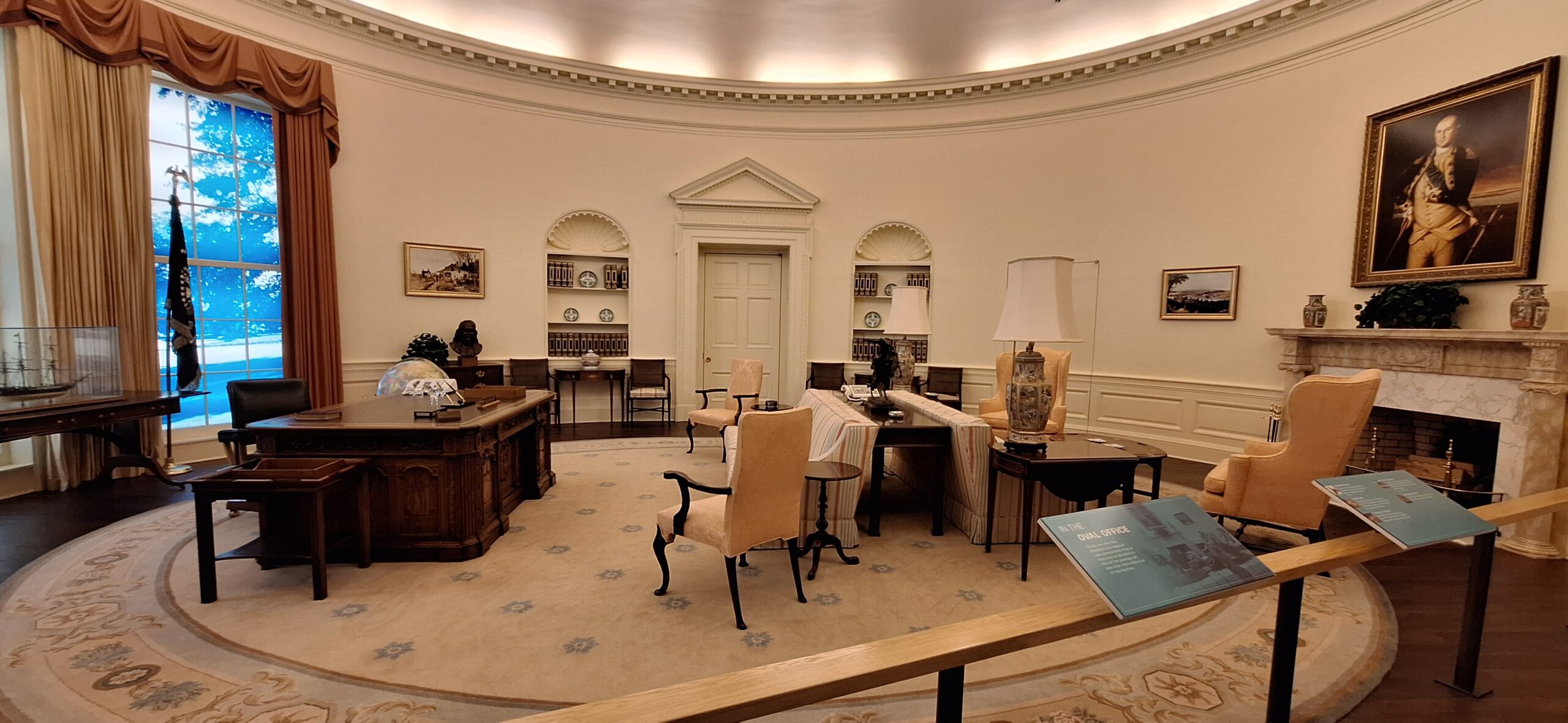 a room with a desk and chairs