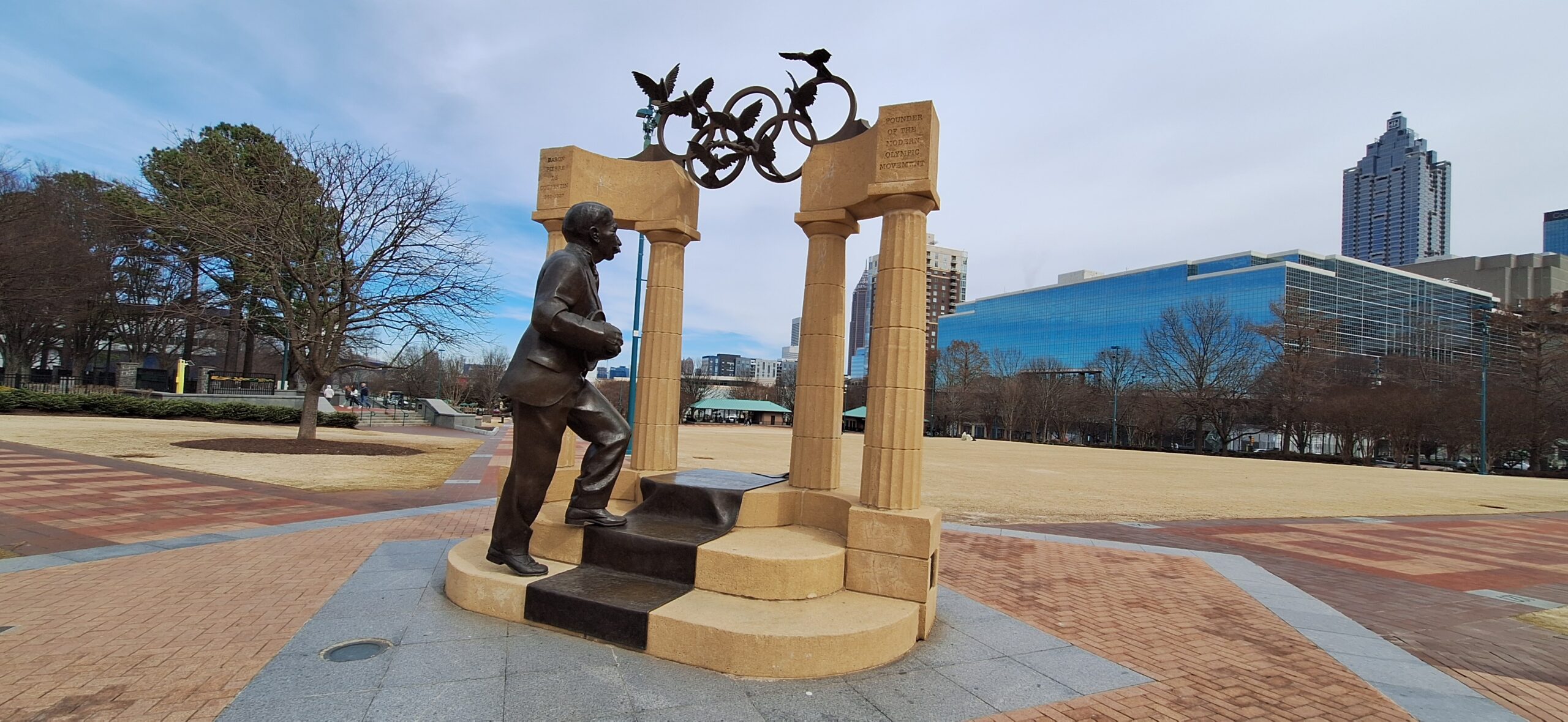 a statue of a man with a bicycle on top of a stone structure