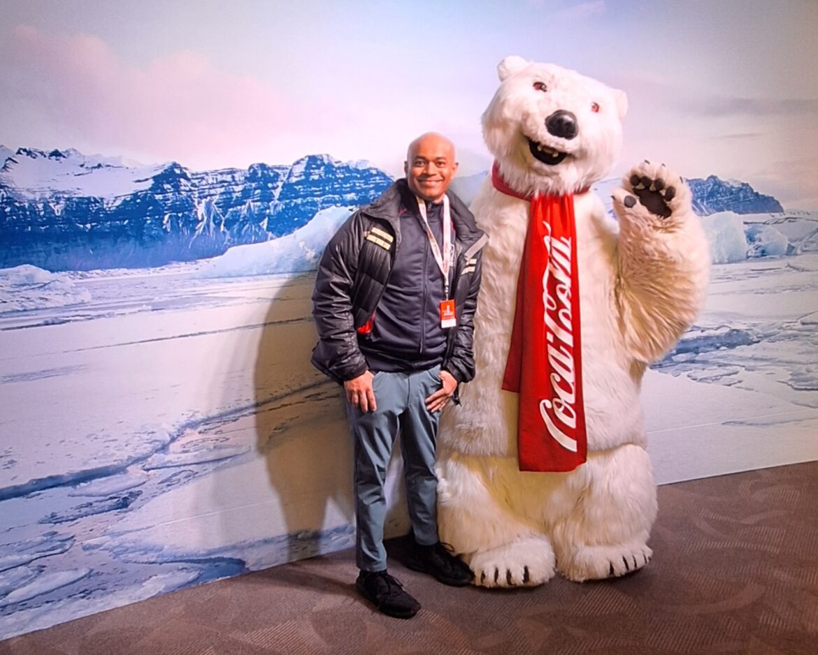 a man standing next to a polar bear