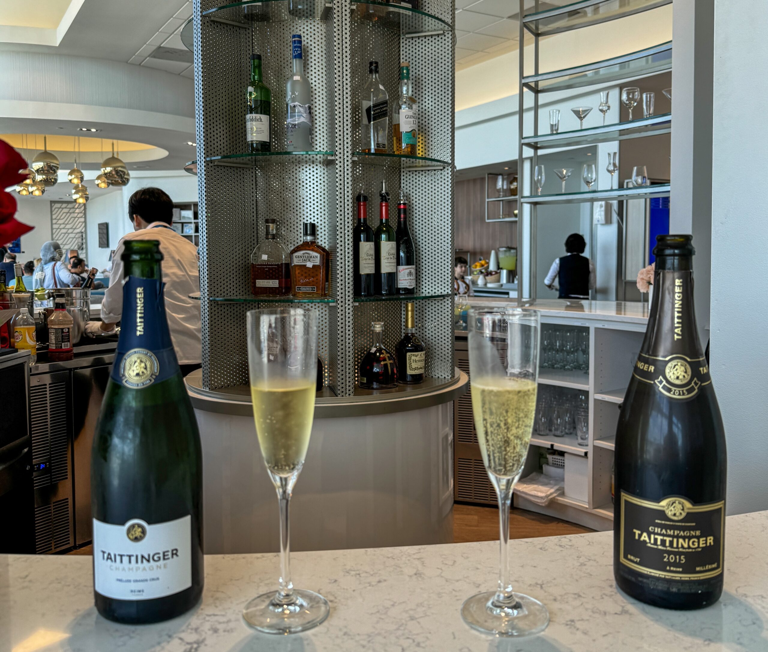 a group of wine glasses and bottles on a counter