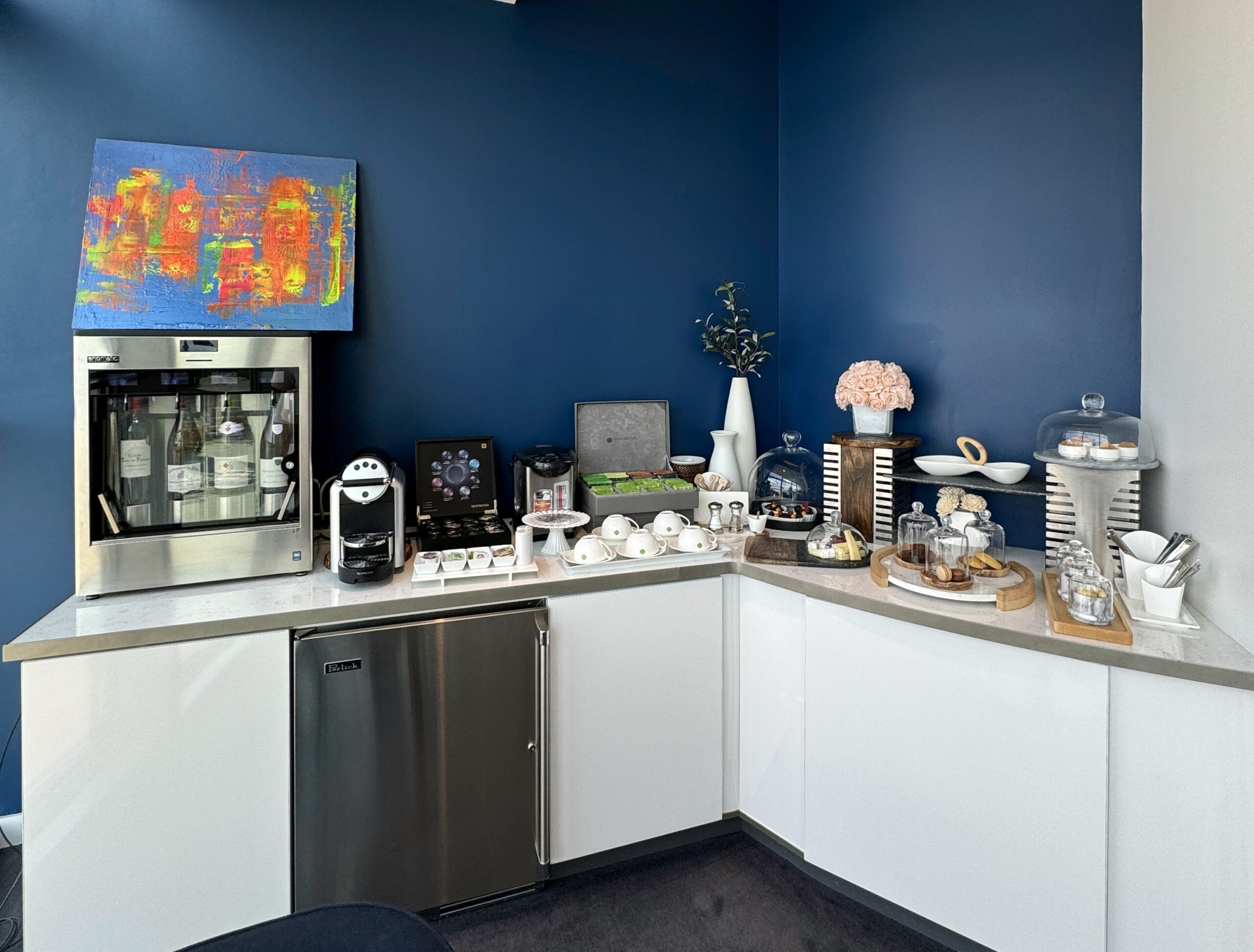 a kitchen with a coffee machine and a refrigerator