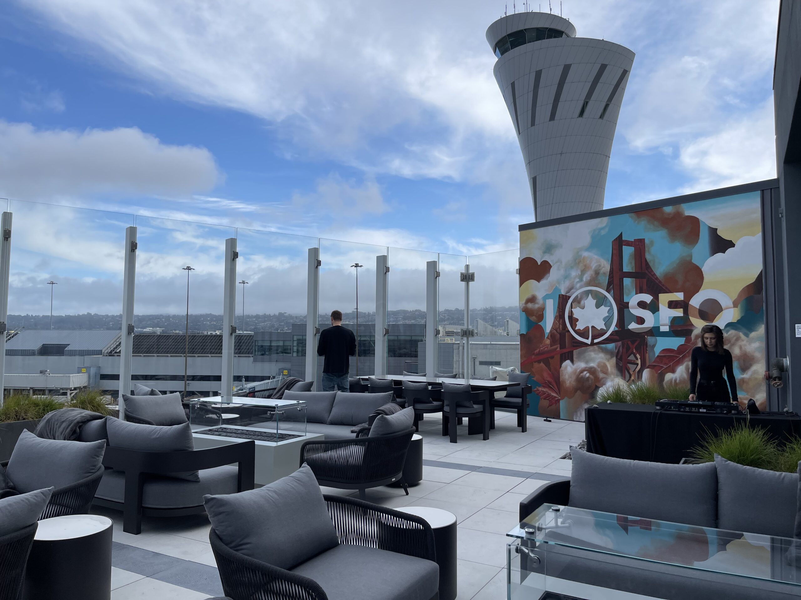 a rooftop patio with a tower and a man standing in front of it