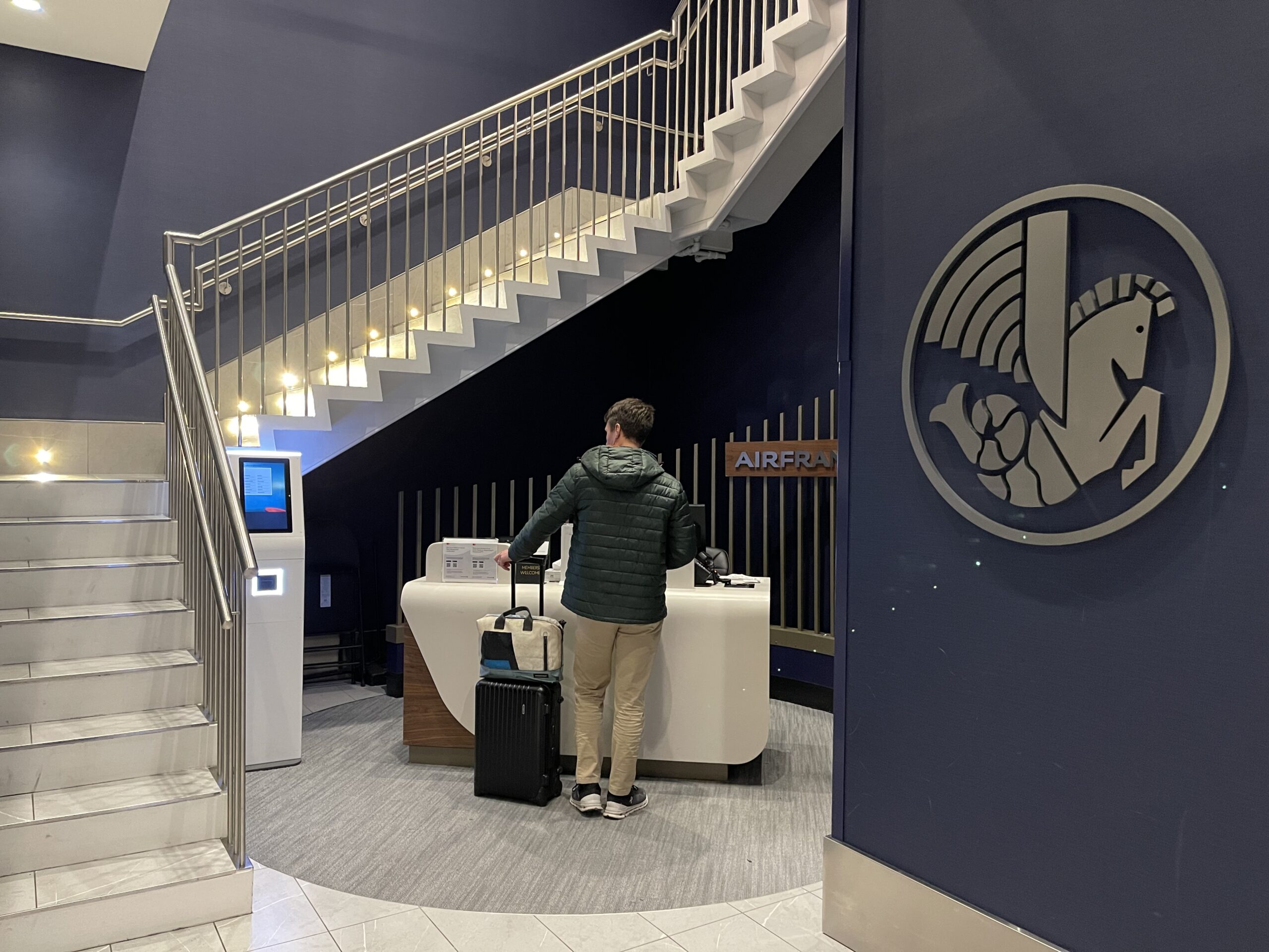 a man standing next to a counter with luggage