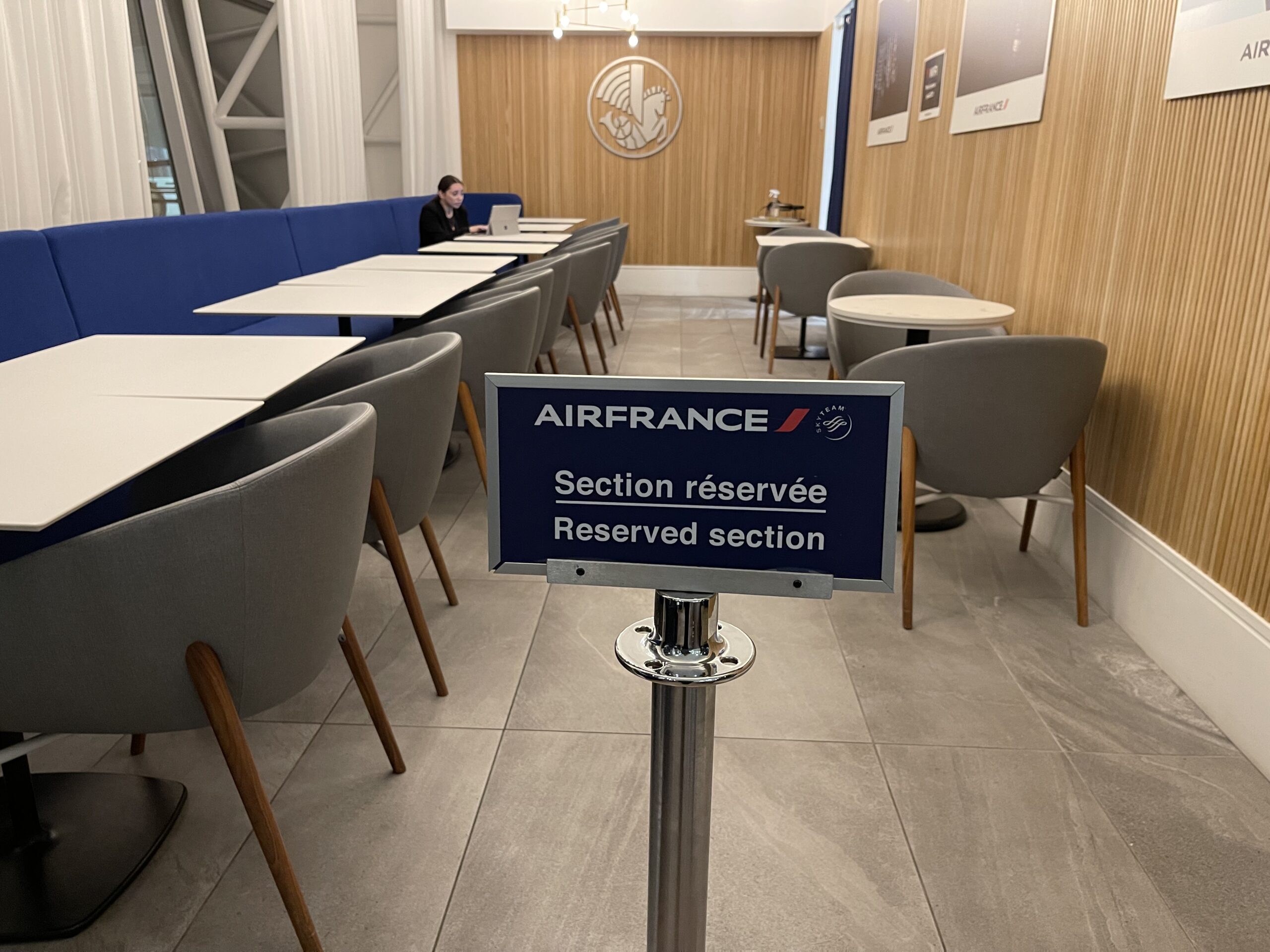 a sign in a room with chairs and tables