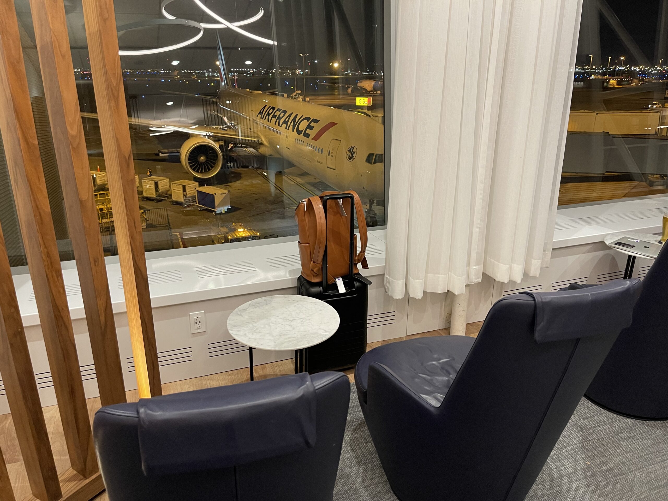 a room with a window and chairs and a plane