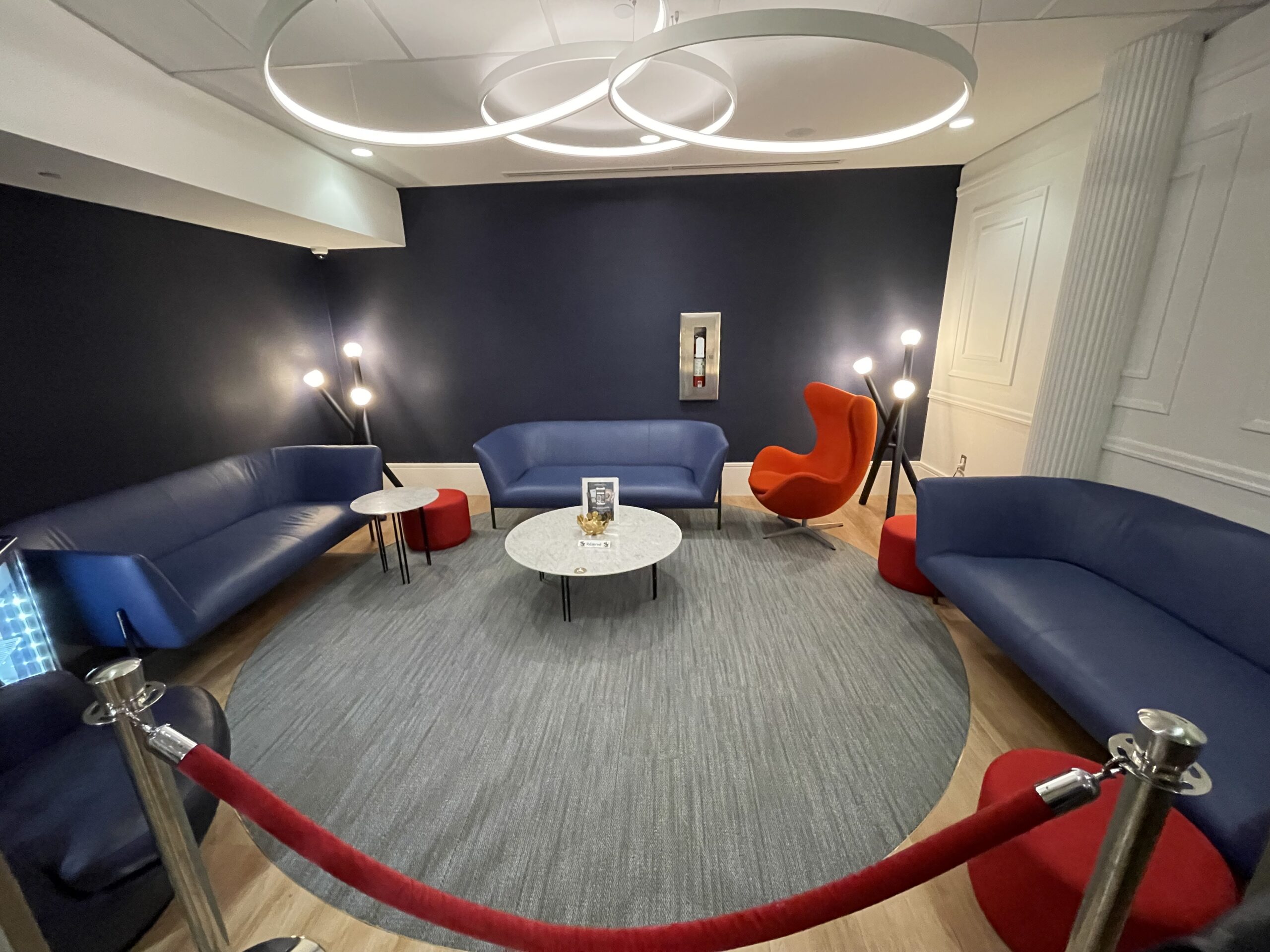 a room with a red and blue sofa and a round table